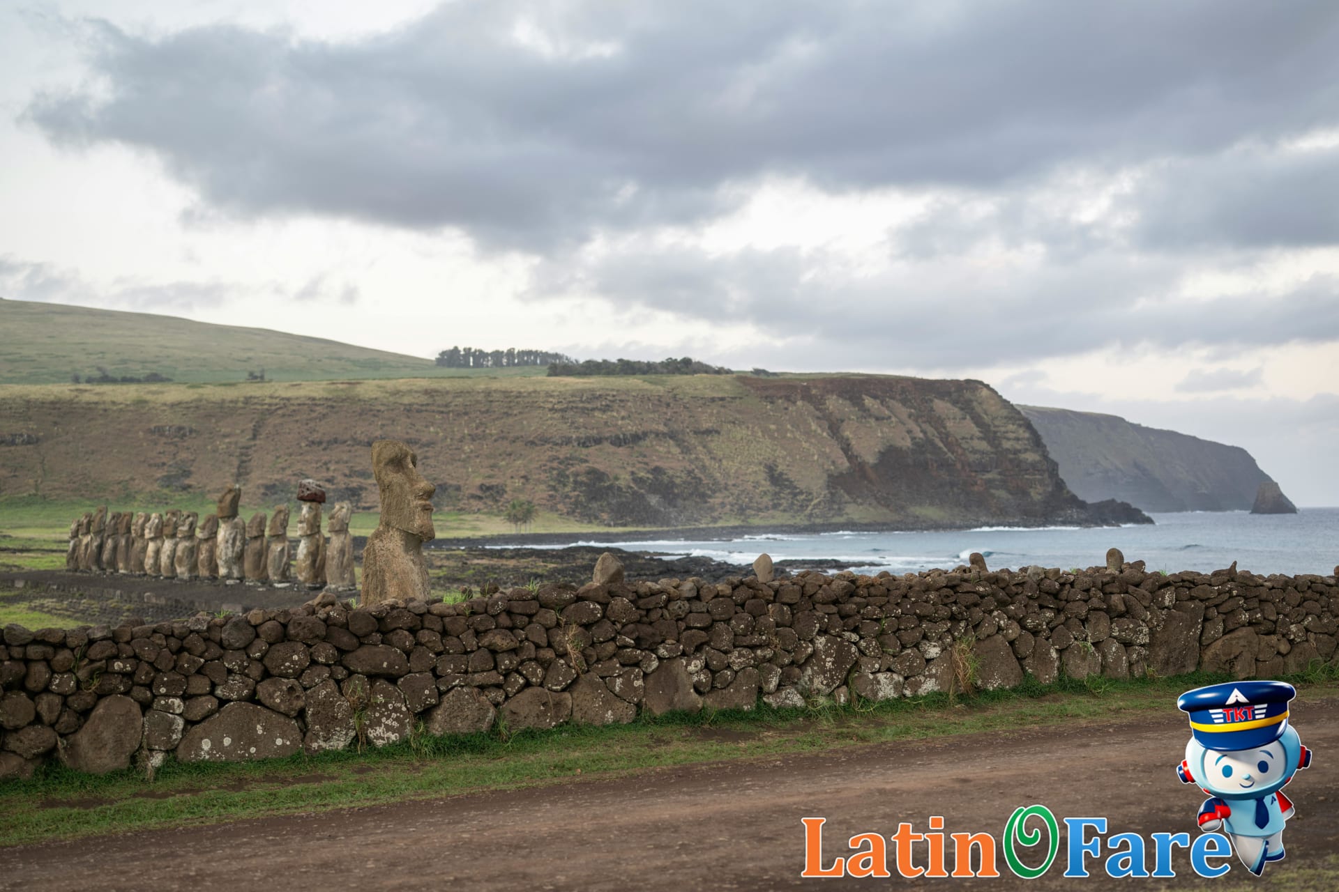 Tourist exploring Easter Island with Moai statues along pathway.