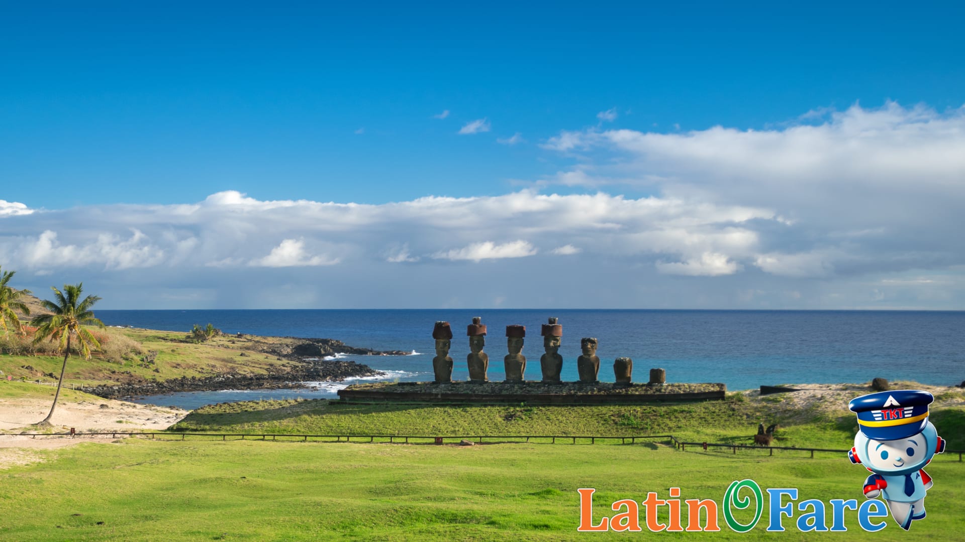 Stunning aerial view of Easter Island Moai against green cliffs coastline.