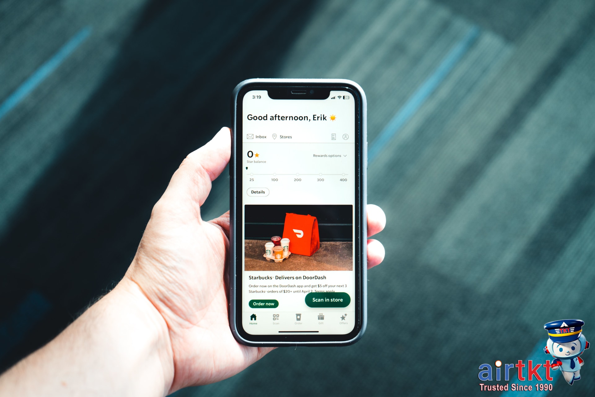 Traveler checking translation app subscription costs on smartphone screen in a café setting