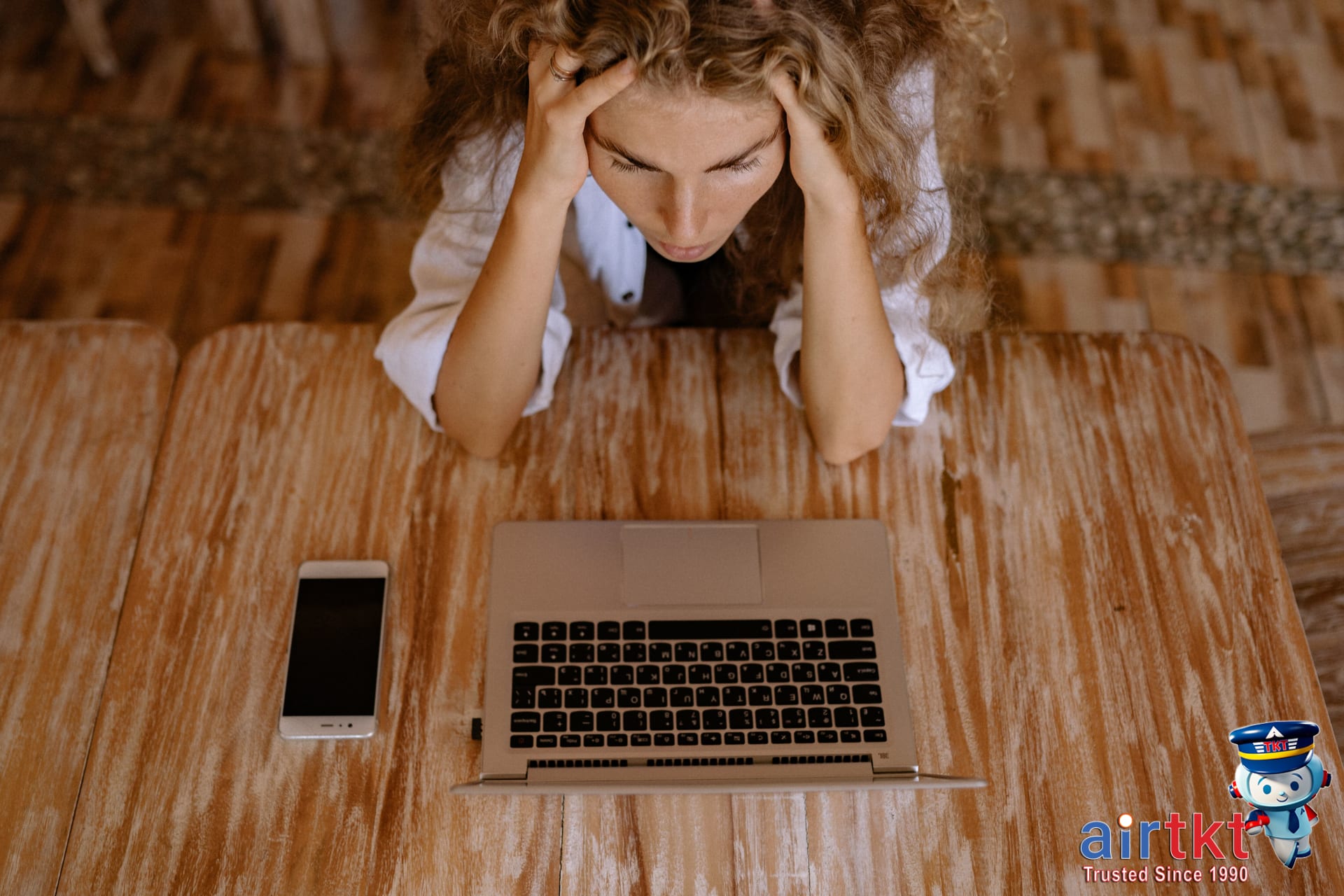 Frustrated traveler checking worst days to book flights on laptop at home