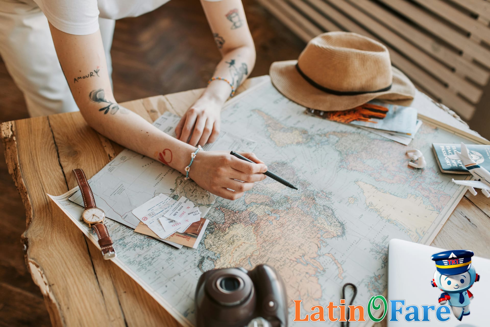 Budget travel planning with map, passport, and airline tickets on wooden table