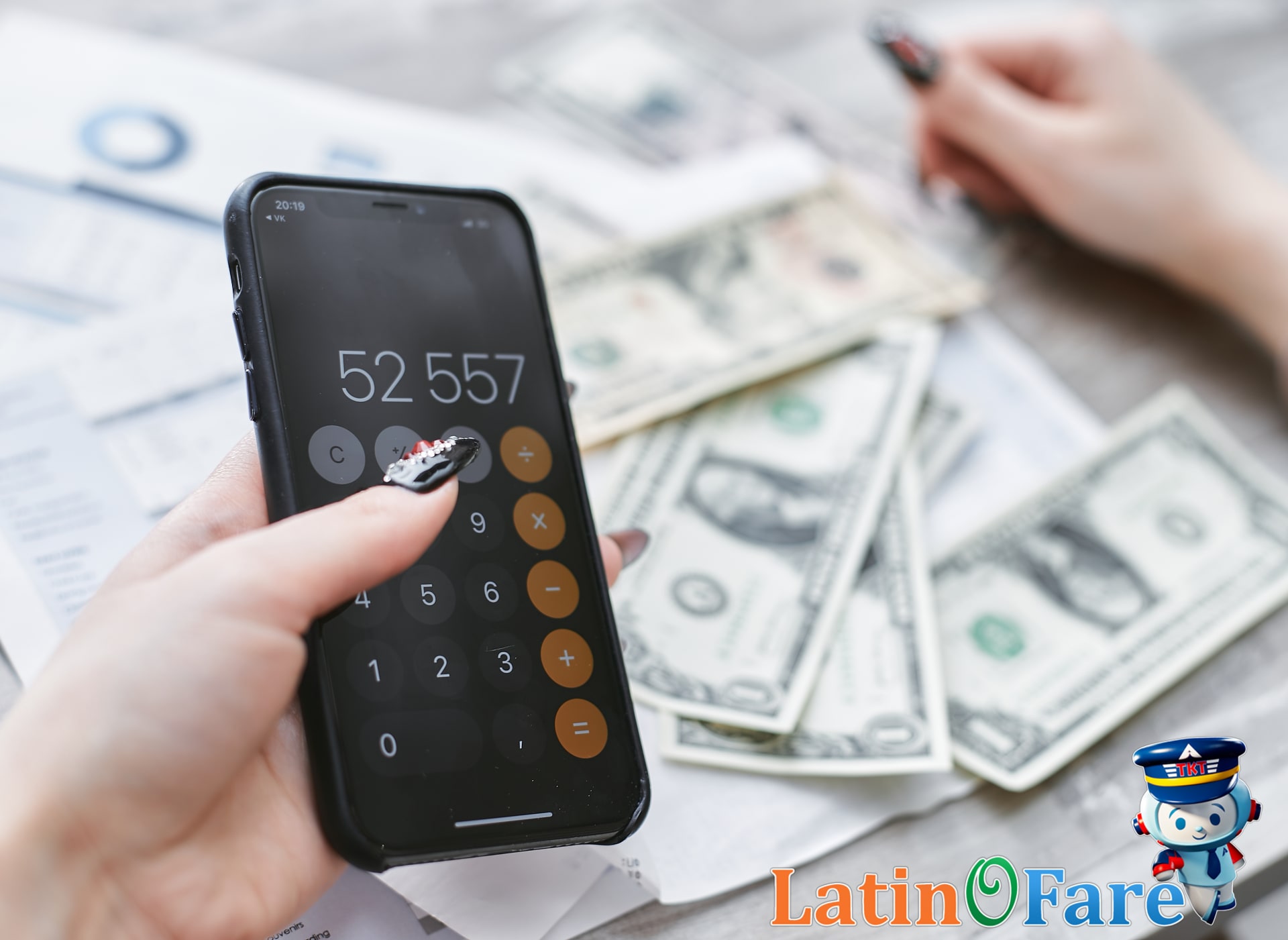 Traveler reviews trip budget on smartphone calculator, dollar bills for value destination planning