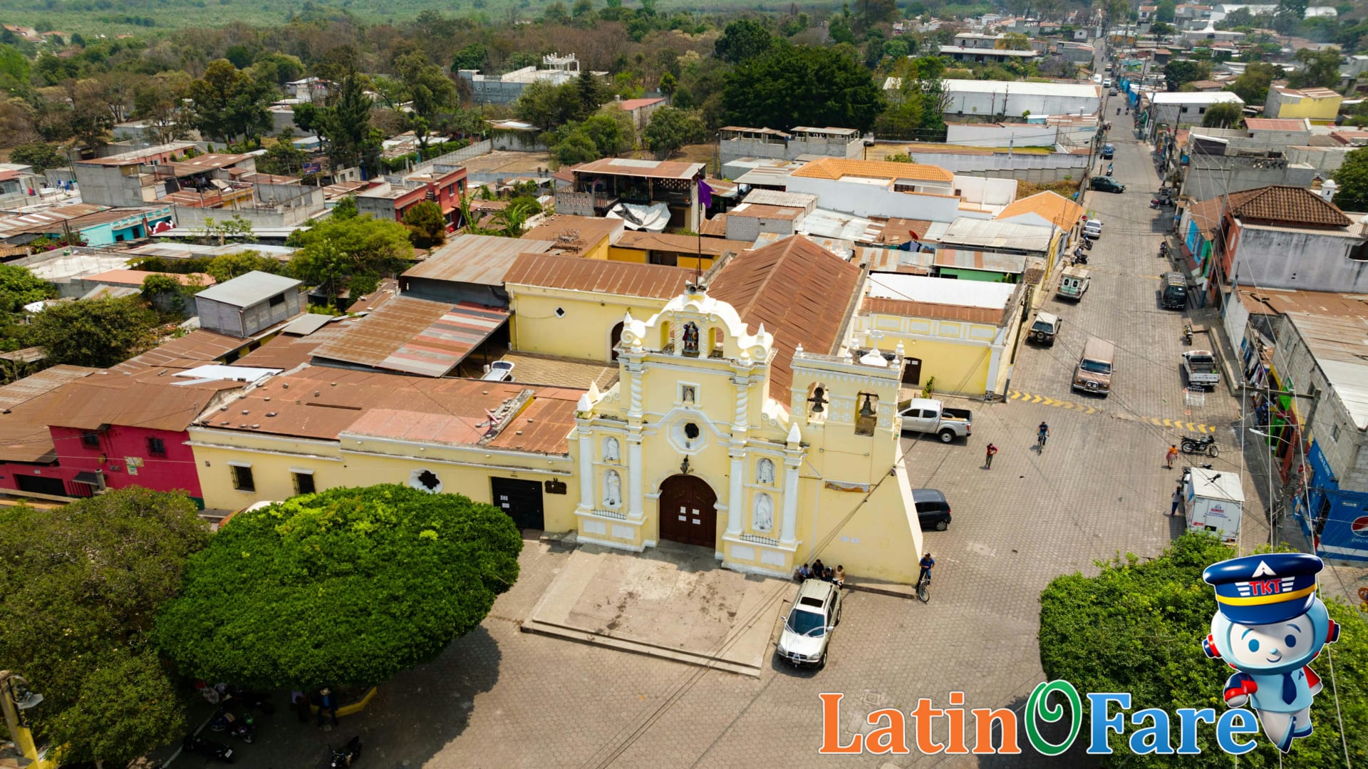 Lively plaza in Central America with historic buildings and active marketplace for budget travel adventures.