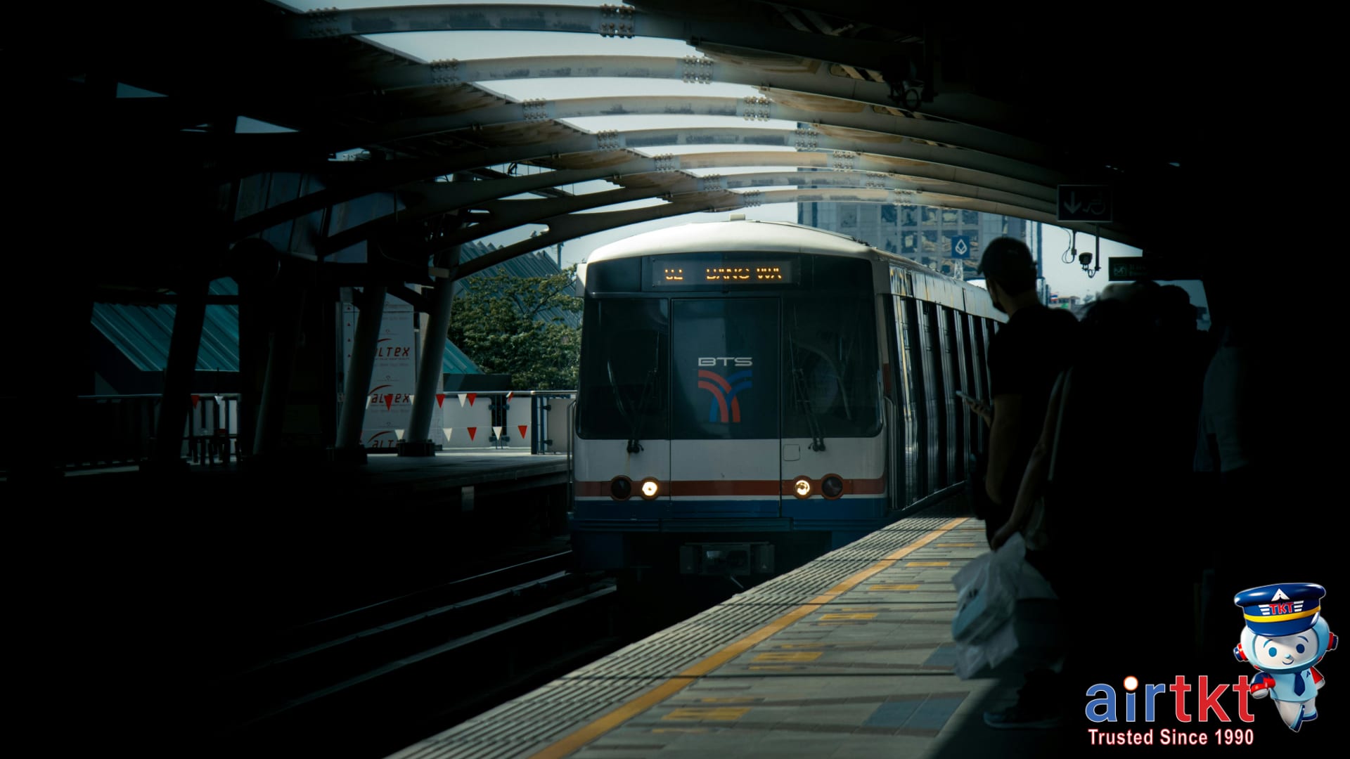 Train arriving at airport transit station under daylight