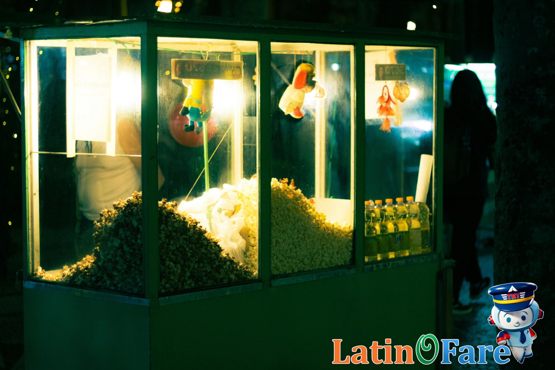 Vendor selling authentic street food at Rio Carnival celebrations with festival crowd in background.