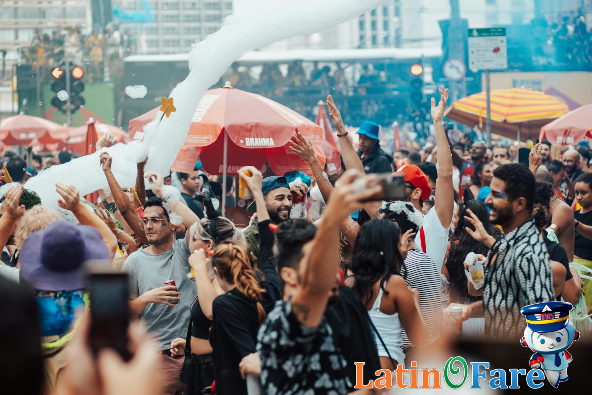 Large festive crowds during Rio Carnival with visible safety barriers and police presence.