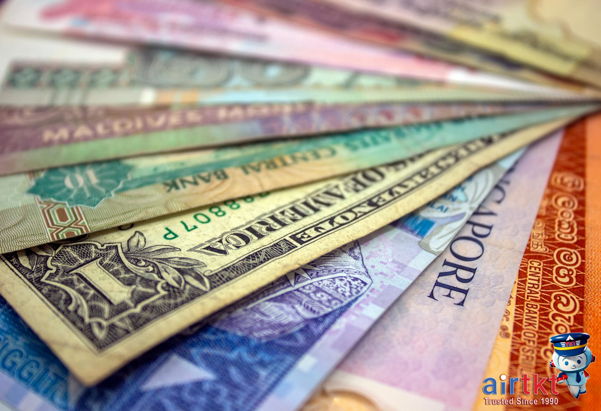 Various foreign currencies for currency exchange tips with bills fanned out