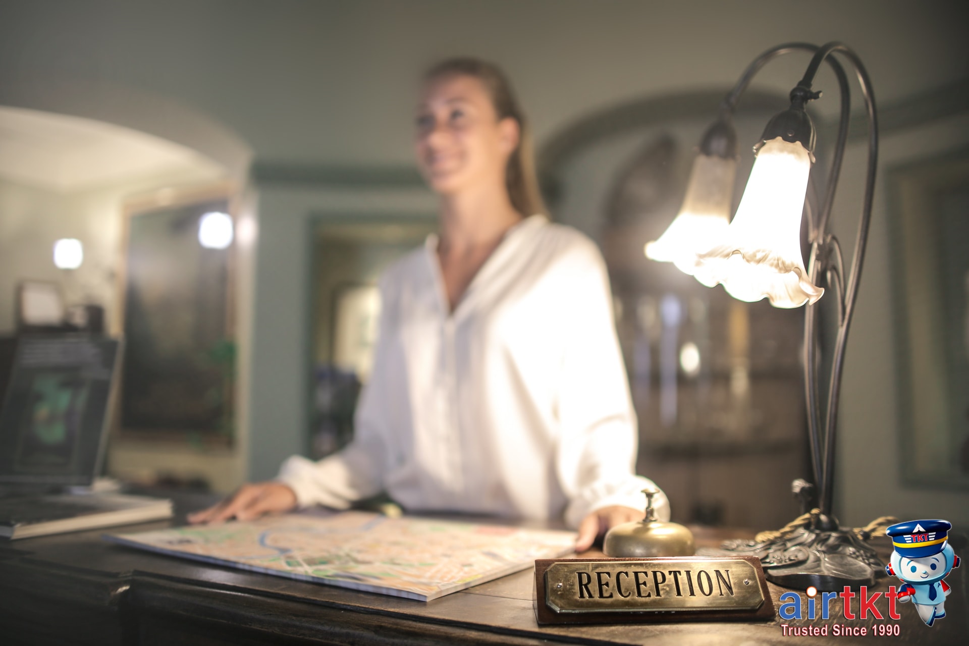 Expert customer service helping traveler with hotel loyalty points strategies at a reception desk