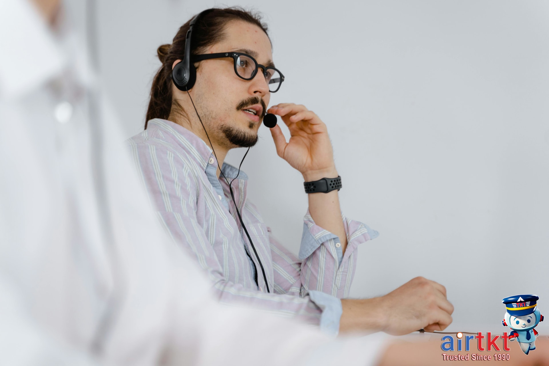 Call center agent providing flight booking support via phone headset