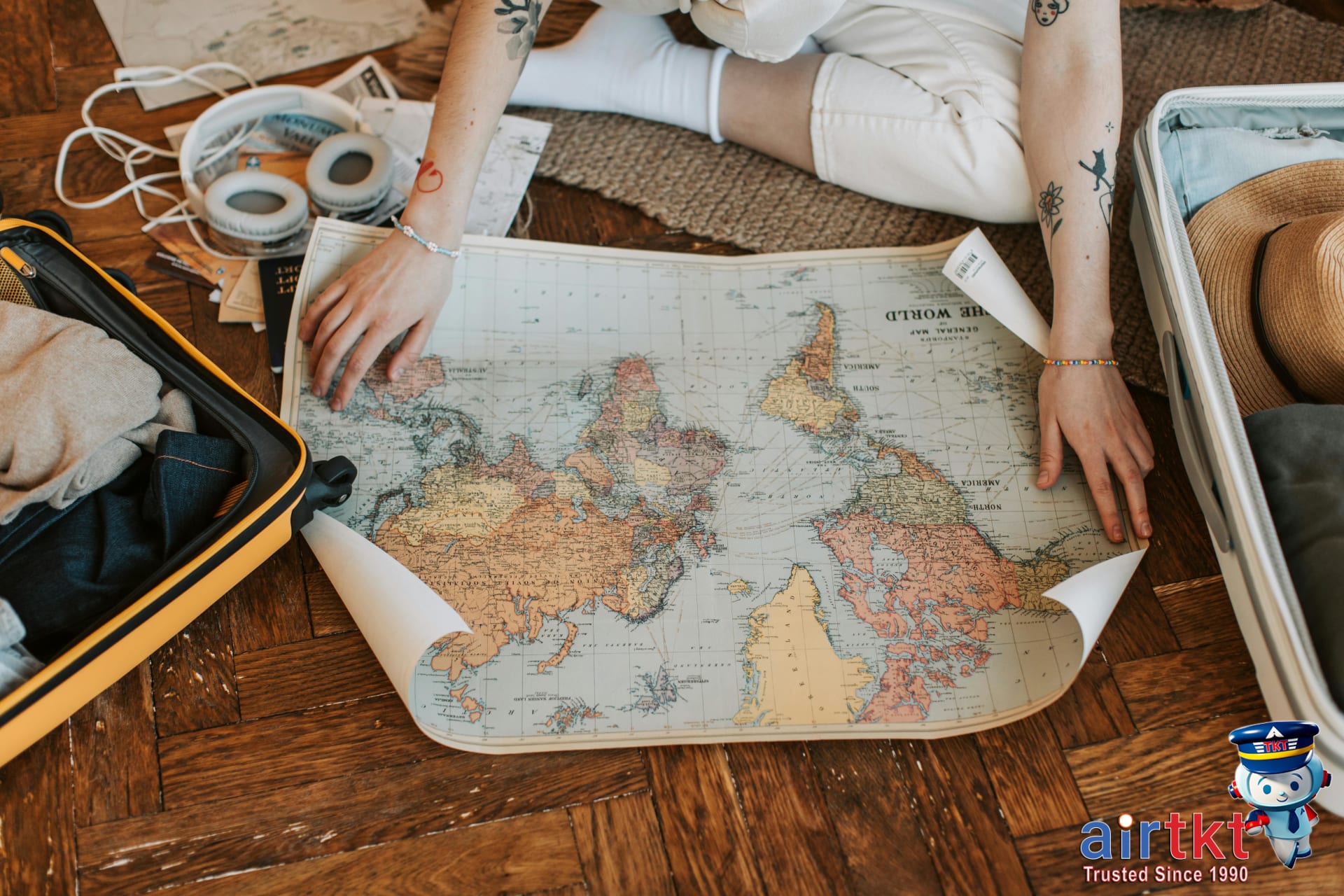 Traveler planning multi-city trip packing suitcase with travel essentials