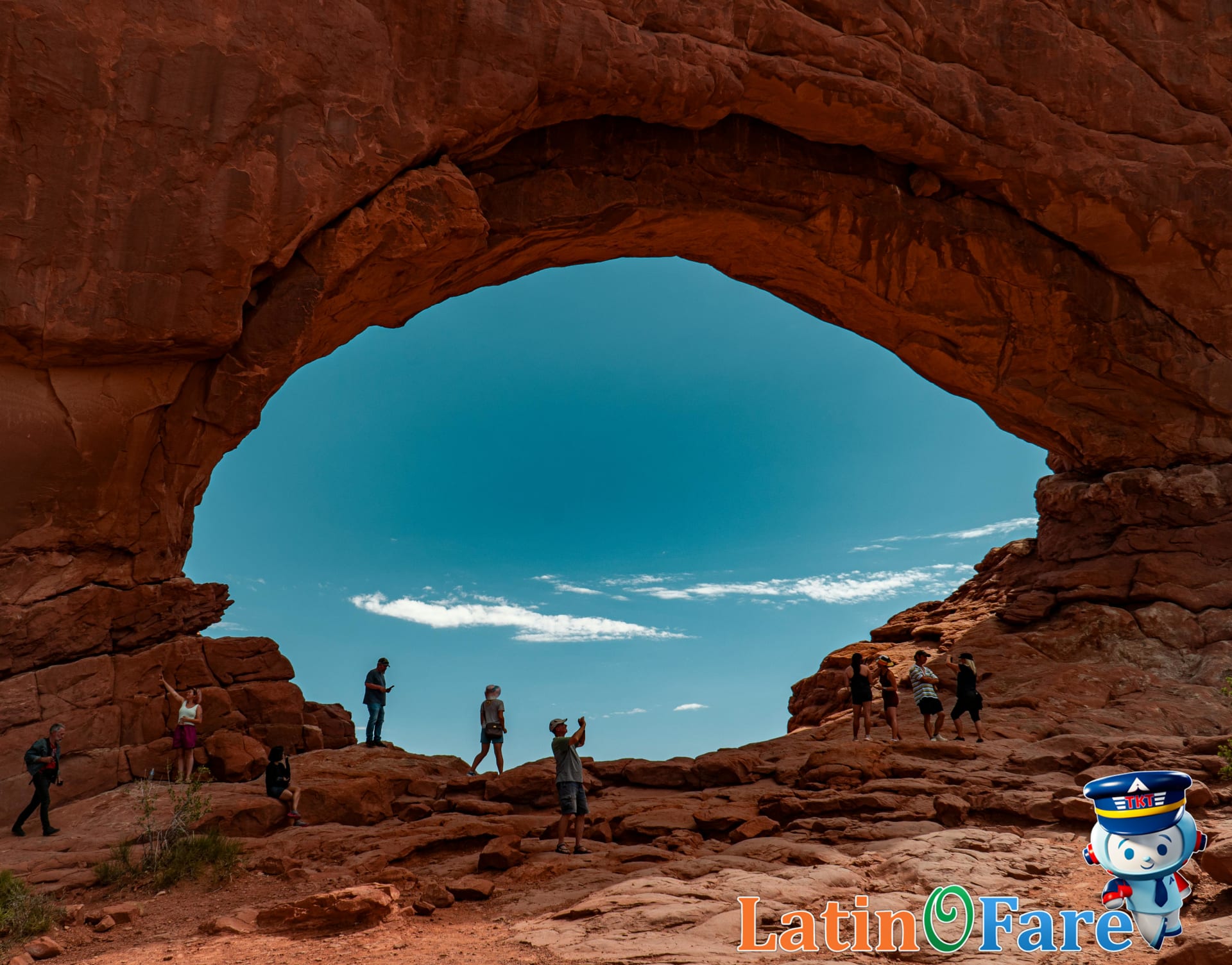 Hikers exploring iconic arches in Arches National Park on a Utah road trip adventure