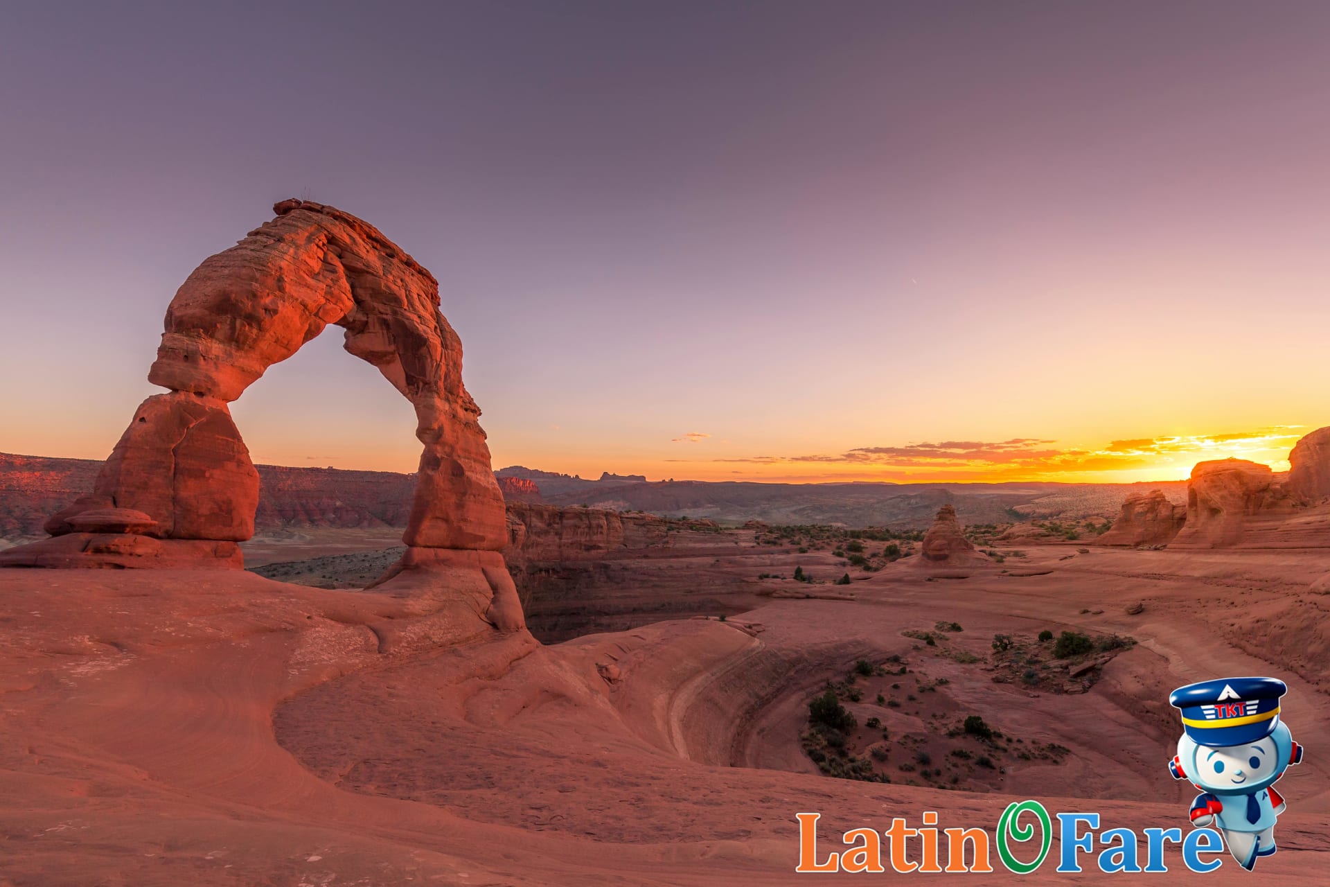 Sunrise illuminating Delicate Arch on a Utah national parks road trip adventure