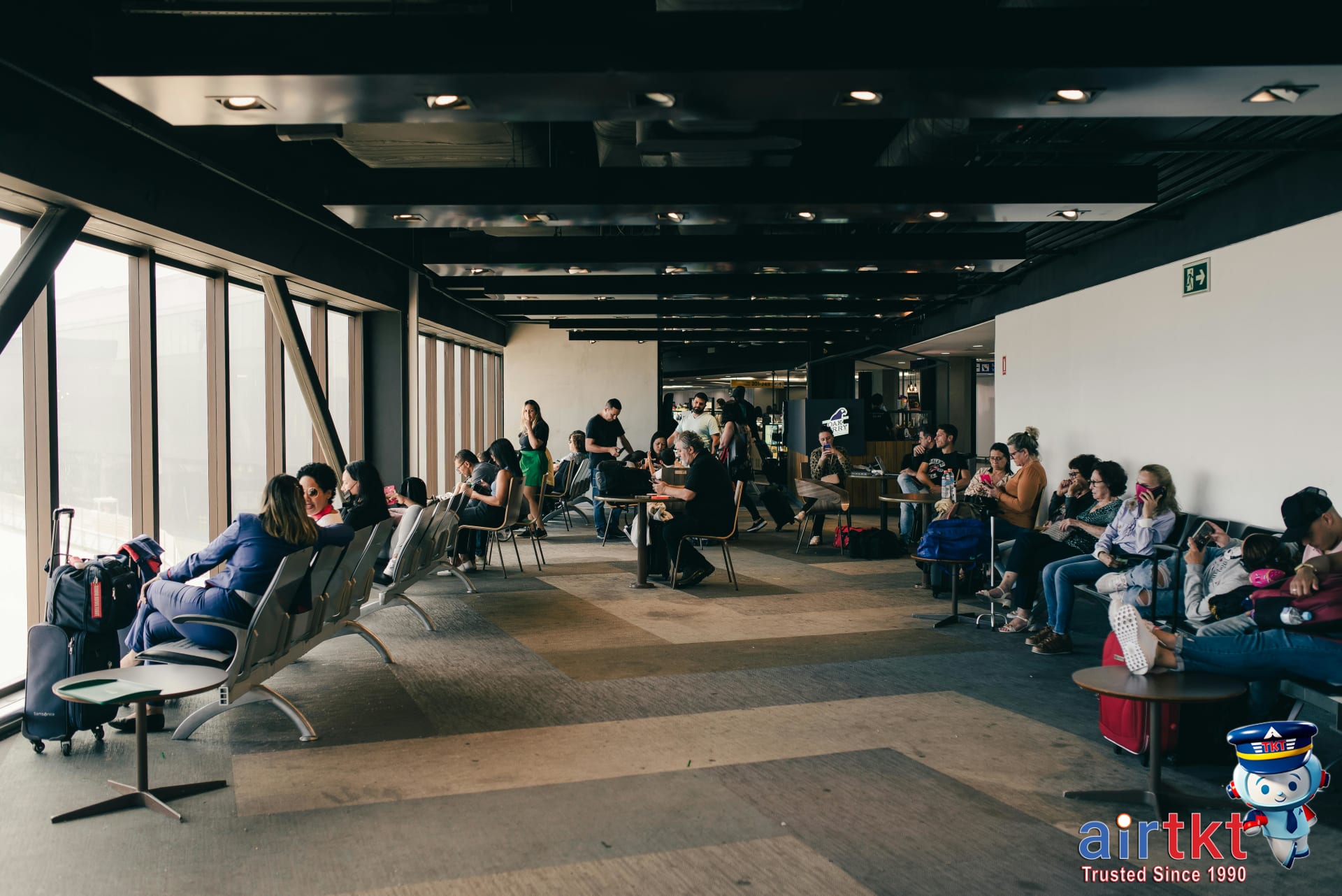 Full-service airline lounge with relaxed travelers enjoying complimentary amenities, highlighting extra perks