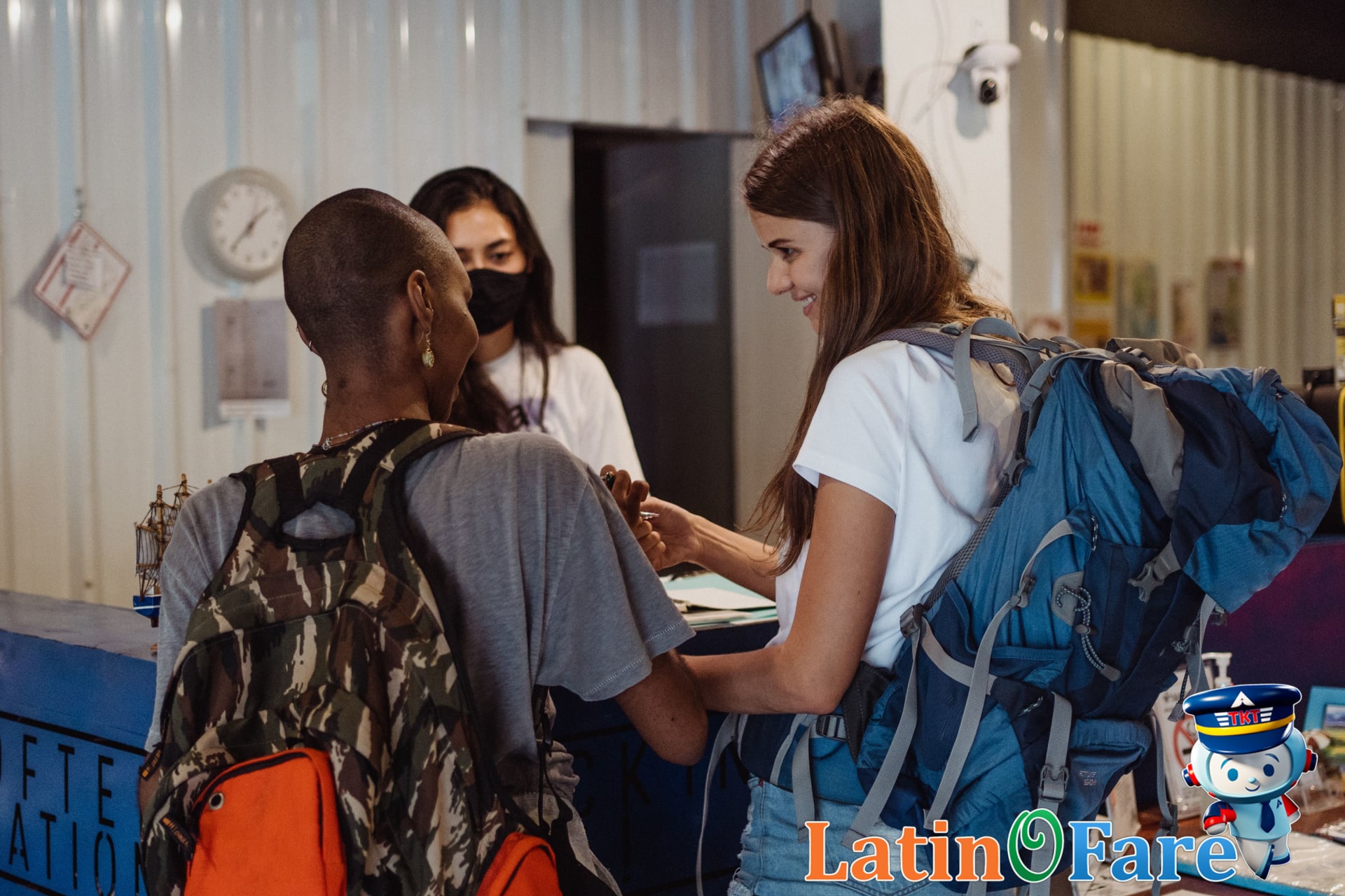 Happy traveler receiving hotel keys after securing the best available rate guarantee.