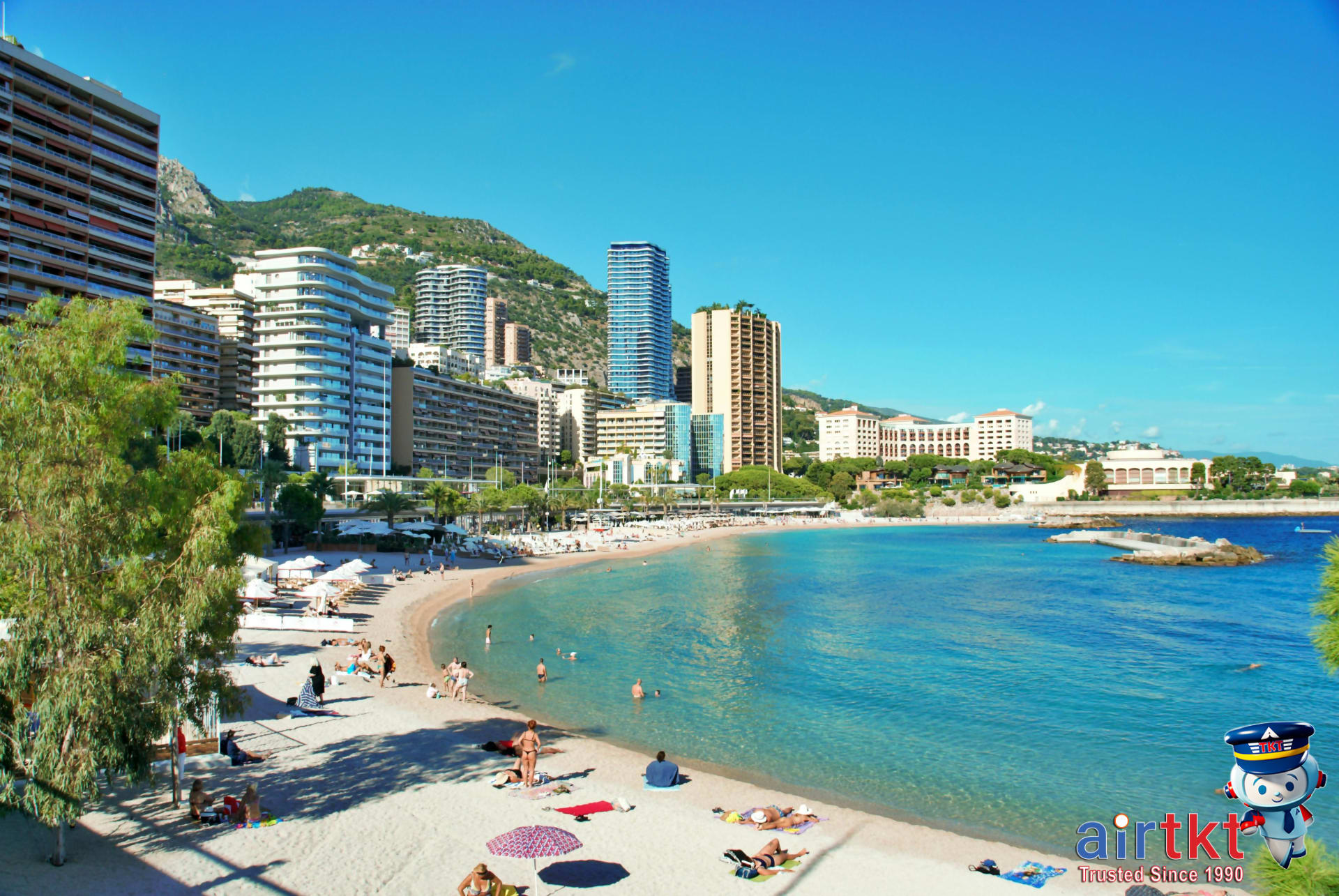 French Riviera luxury beach with yachts and sunbathers docked in harbor