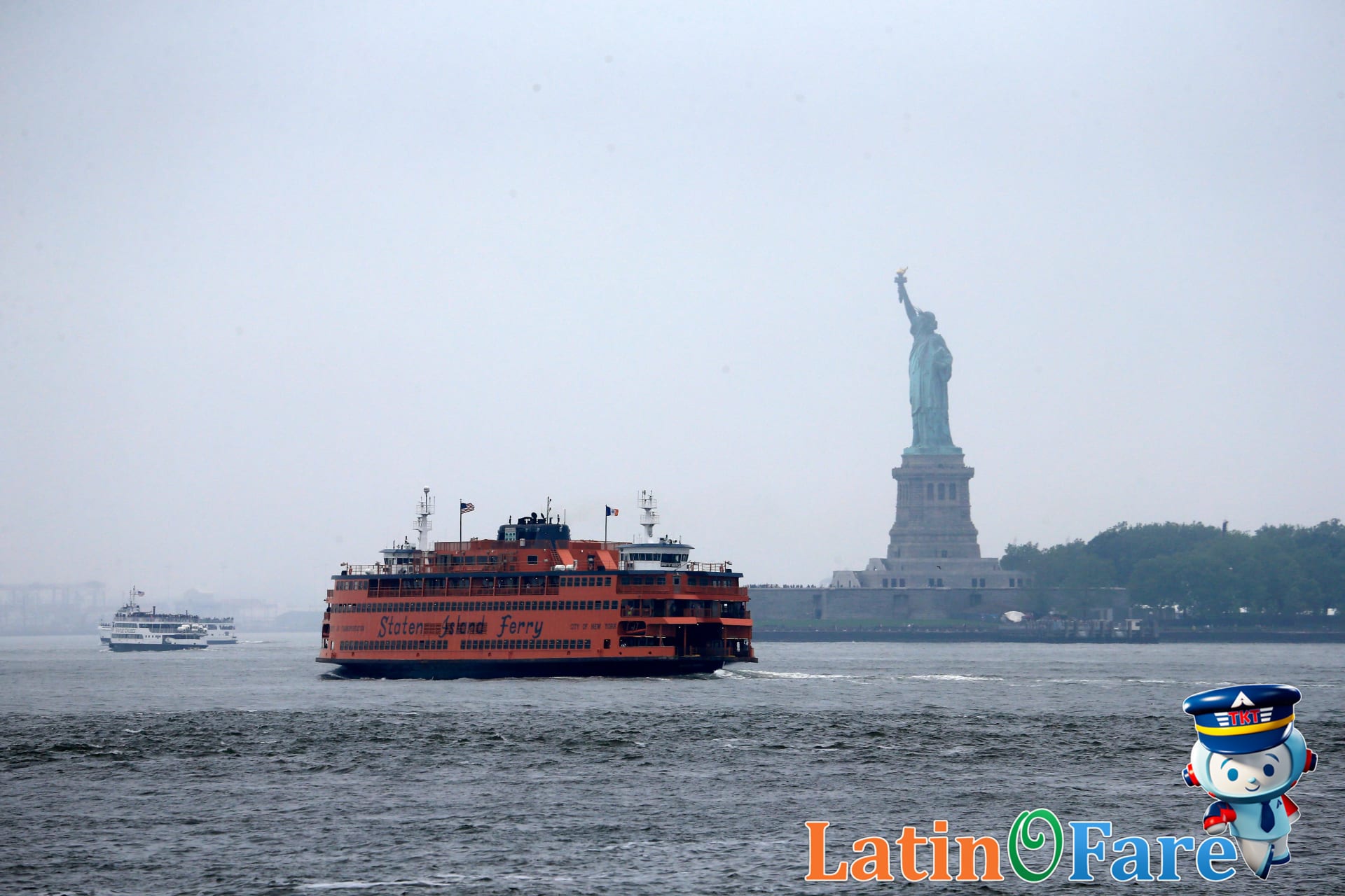 Staten Island Ferry passing Statue of Liberty with budget travelers on deck.