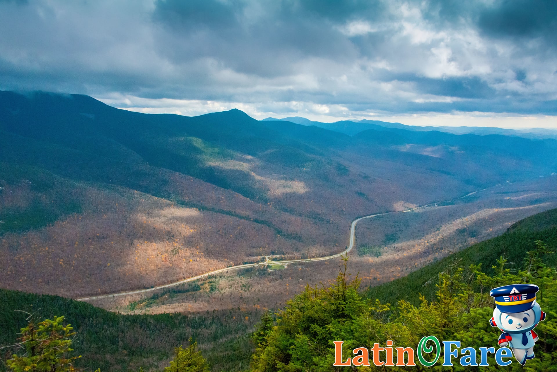 Travelers at popular New England overlook experiencing stunning peak autumn foliage views and fall colors.