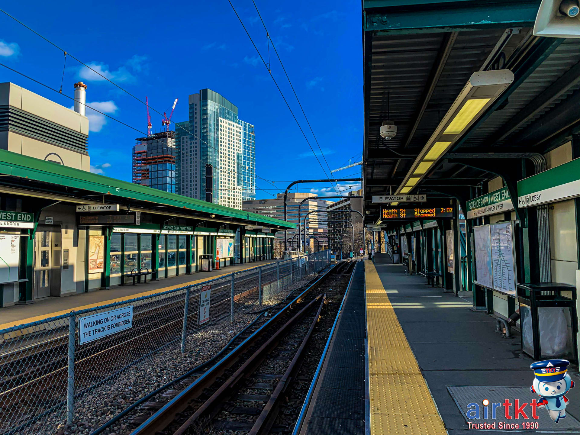 MBTA Commuter Rail train arriving at Boston station platform on a busy afternoon