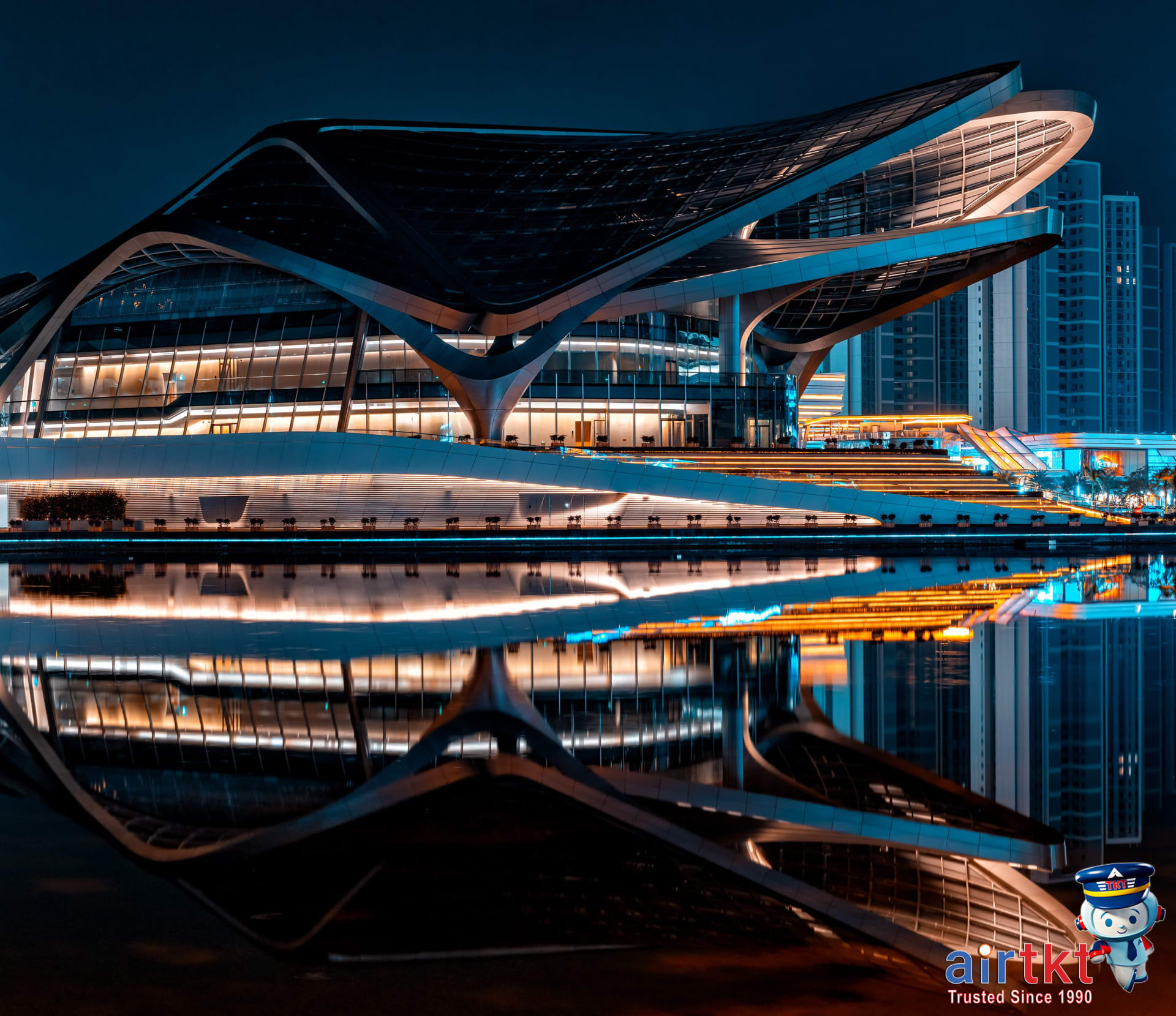 Marriott hotel exterior illuminated at night with vibrant city lights and Bonvoy card benefits in action