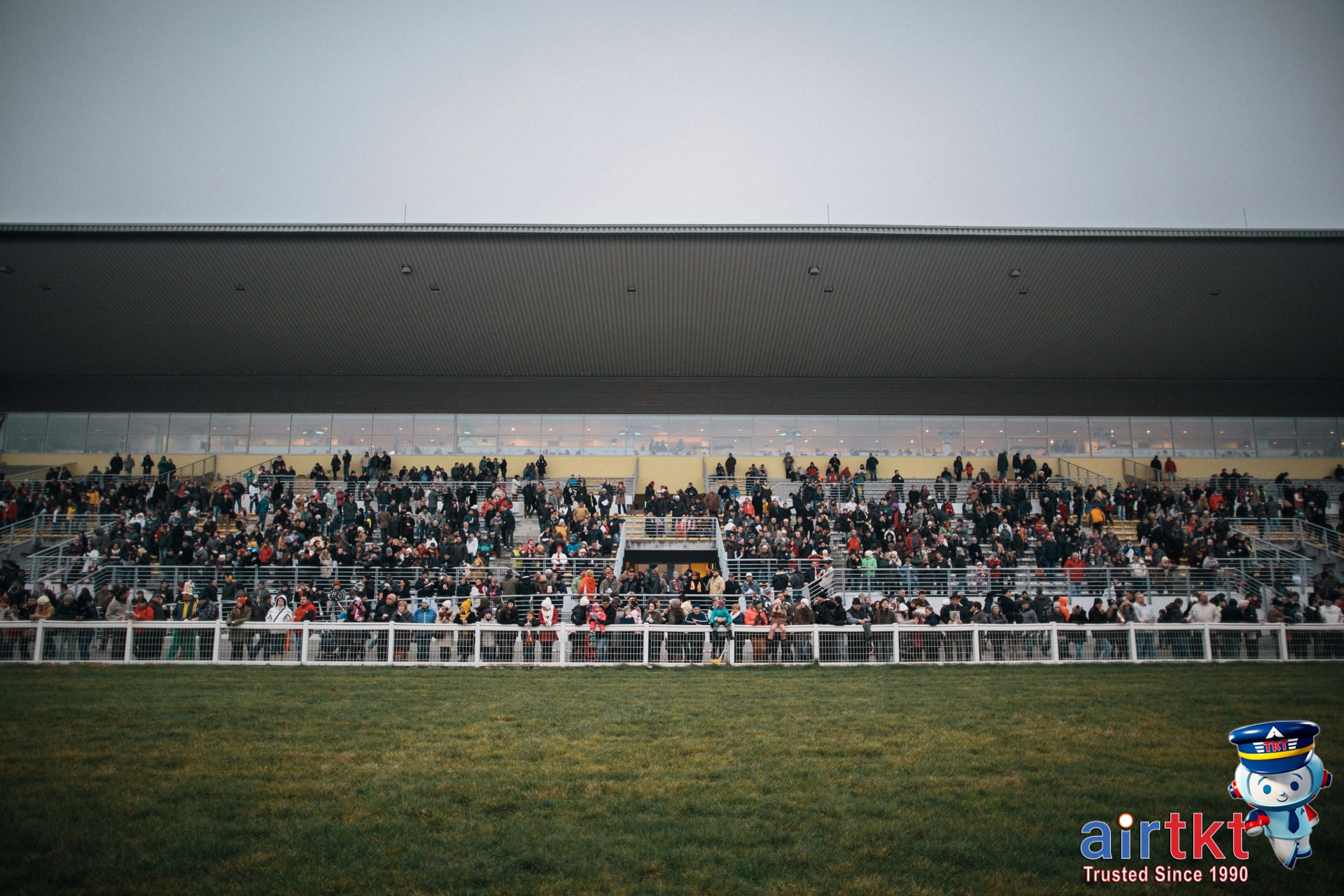 Kentucky Derby crowd at Churchill Downs dressed in colorful attire on race day