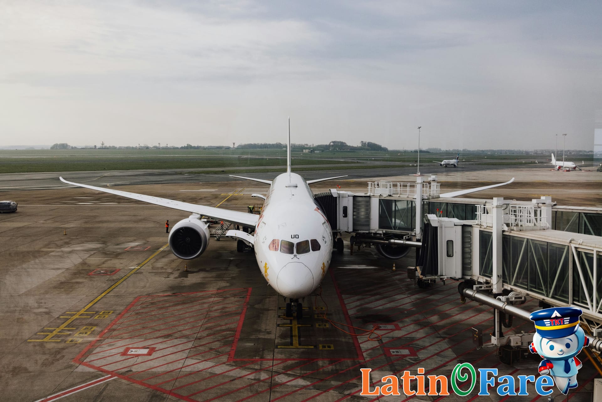 Travelers boarding both budget and full-service airplanes at an airport gate for airline comparison.