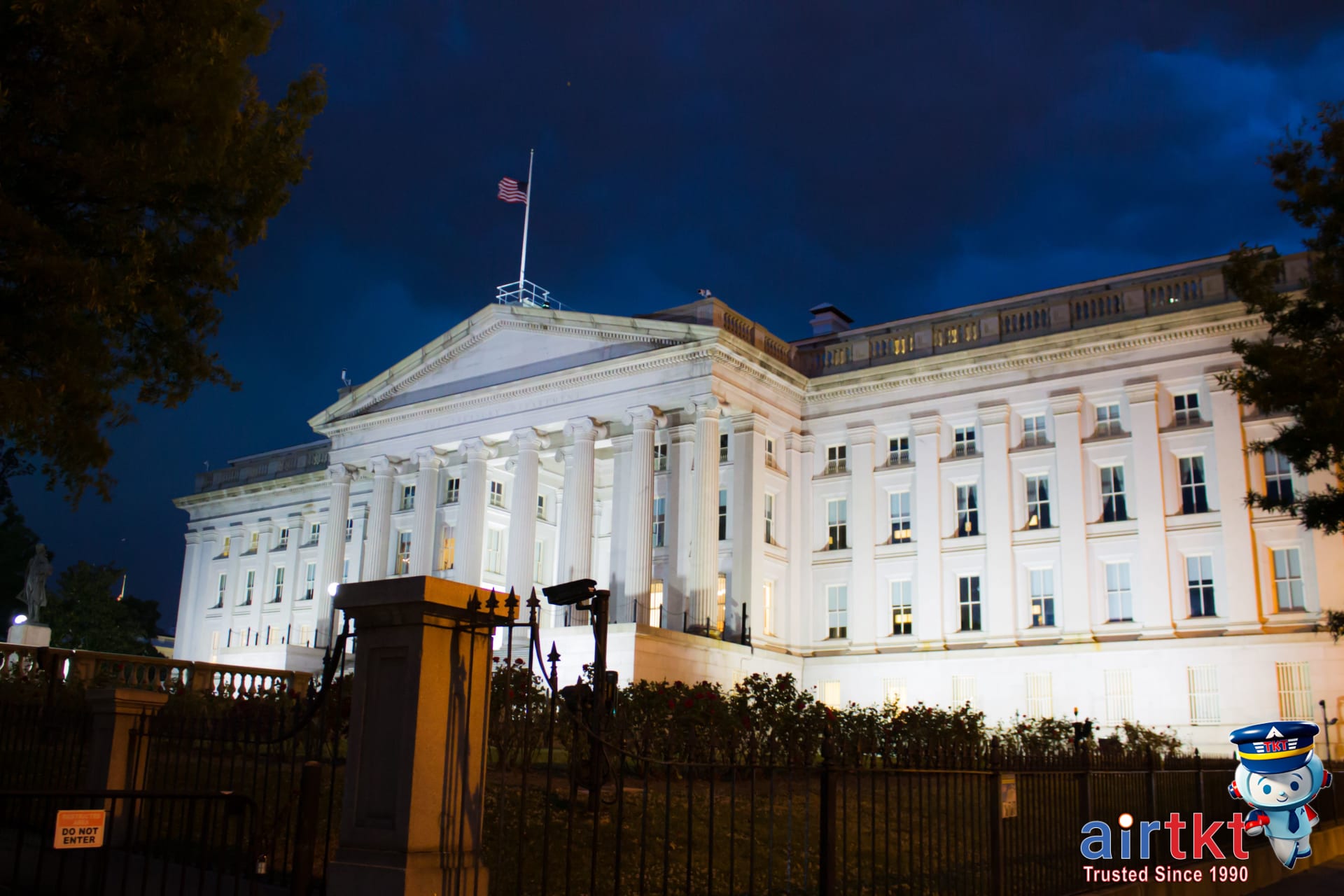 Illuminated US flag on historic building celebrating Flag Day at night