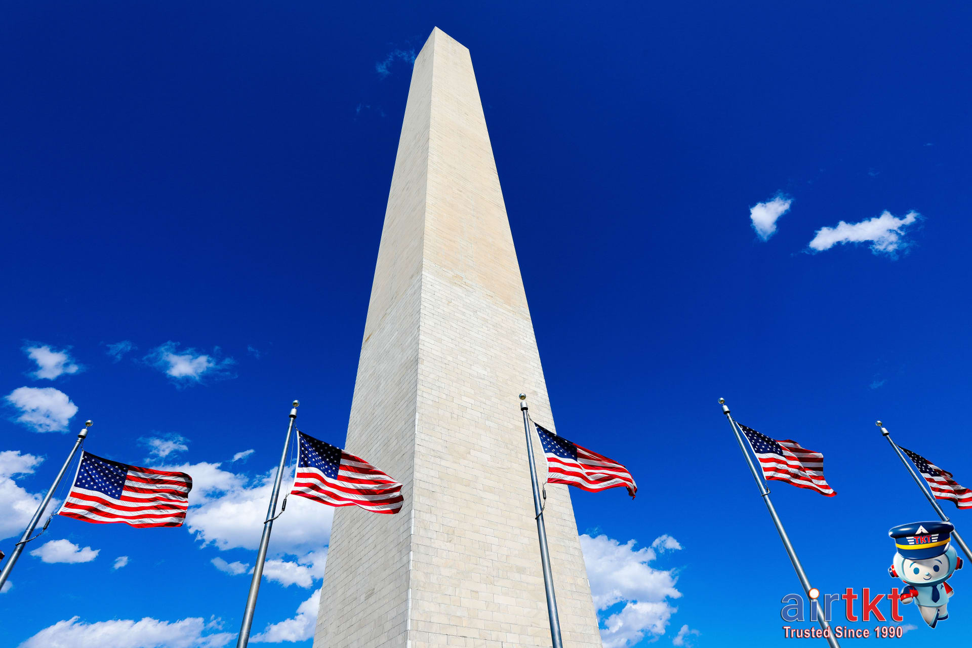 Iconic US national monuments with waving American flags in daylight months