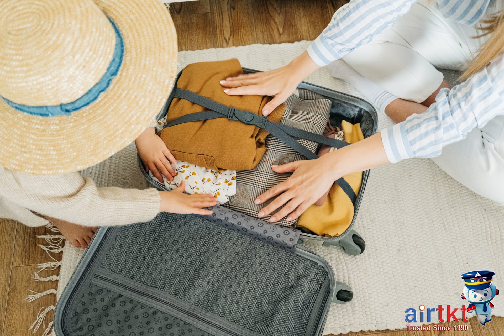 Organized suitcases packed with kids travel checklist items for family trip.