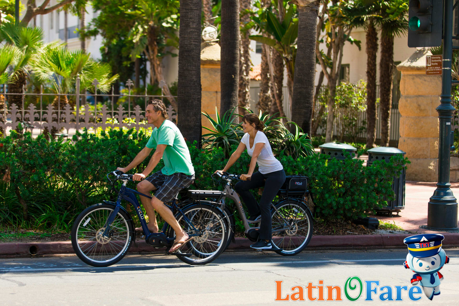 Couple biking together in charming historic city on budget romantic getaway.