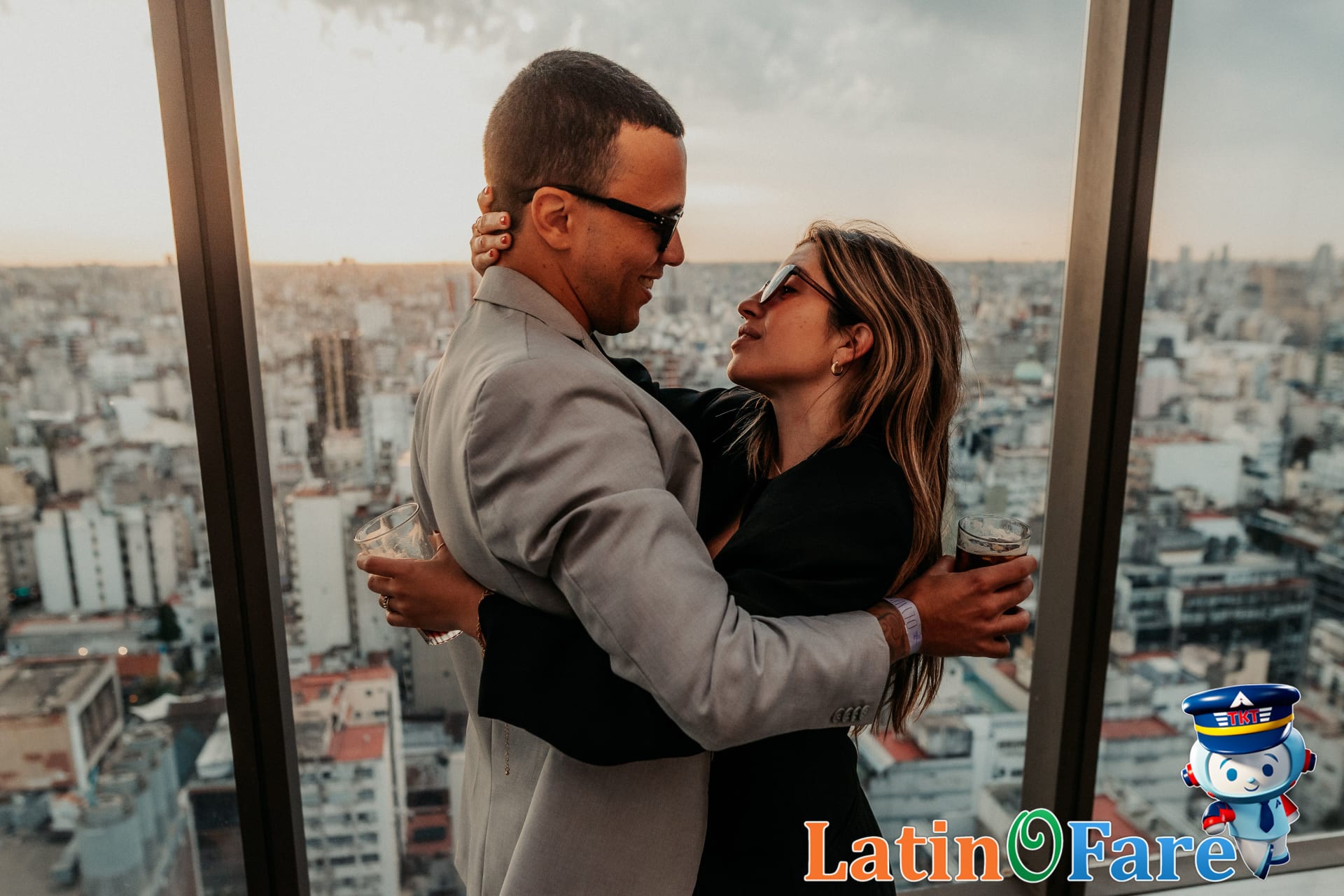 Couple overlooking cityscape from affordable romantic Latin American terrace getaway.