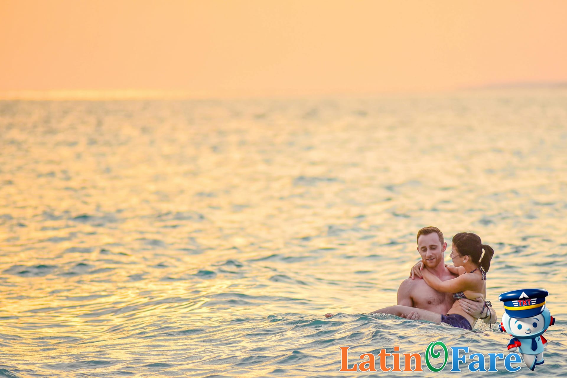 Couple at romantic sunset budget travel destination embracing by the water