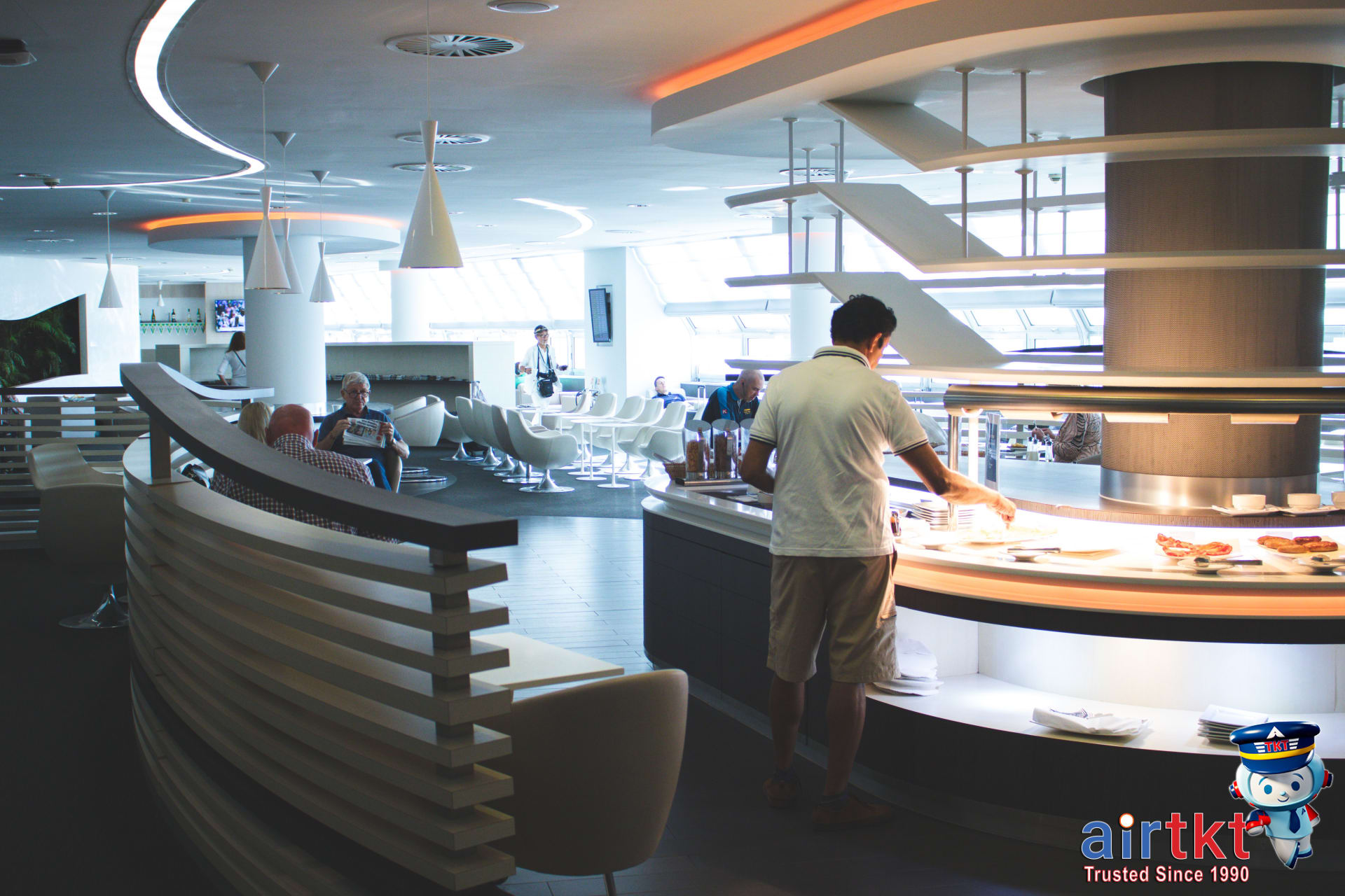 First-class lounge with comfortable seating and complimentary amenities, a major flight upgrade benefit