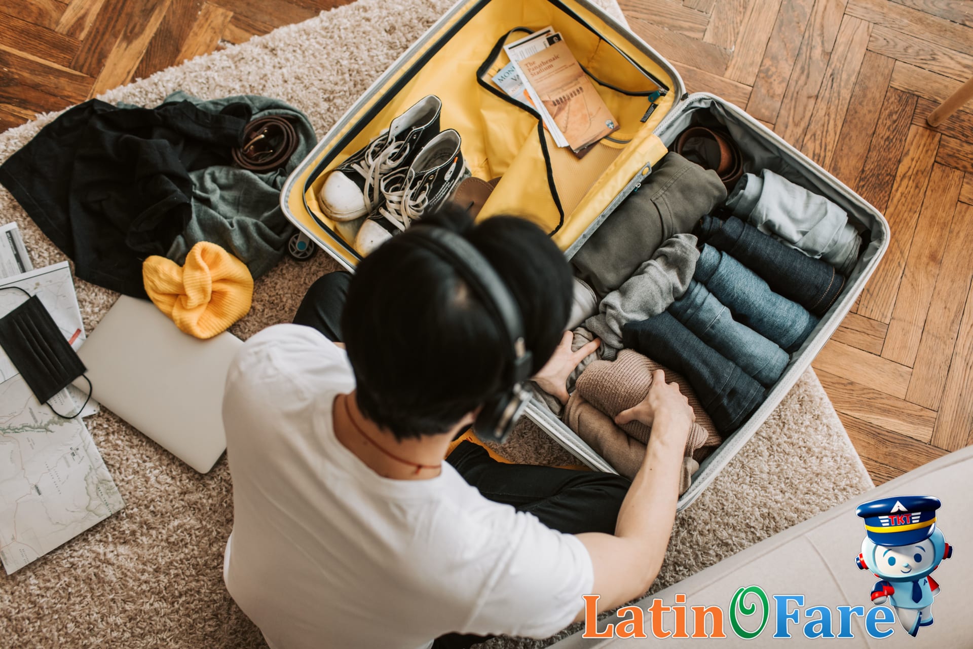 Overhead view of packing cubes filled by clothing type for efficient suitcase organization