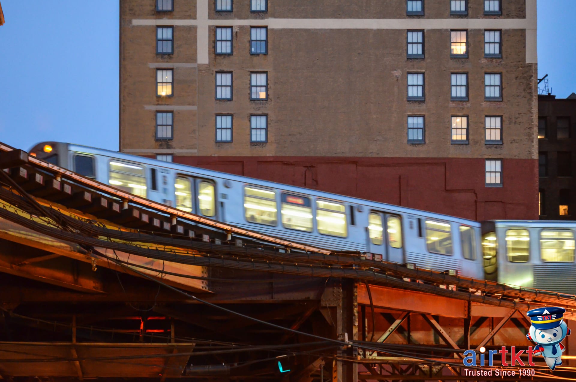 Nighttime view of a Washington DC Metro train running on elevated tracks