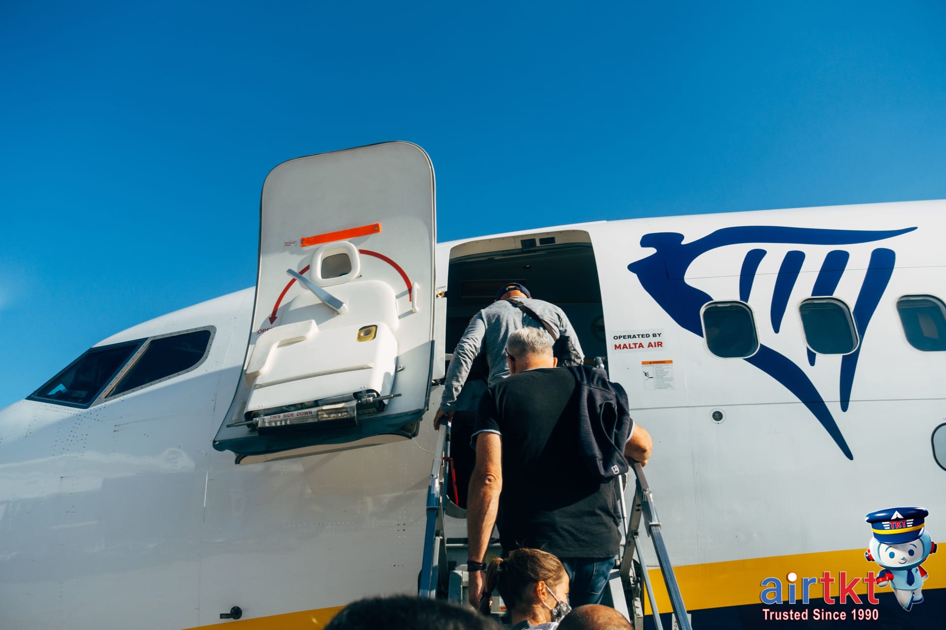 Parent and child at airport boarding airplane to save on affordable family flight fares