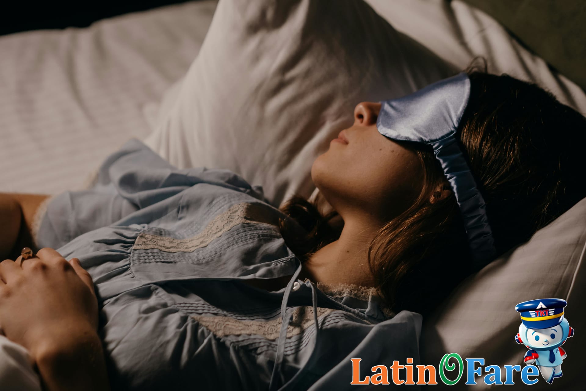 Traveler sleeping with neck pillow and mask on a red-eye flight for better overnight sleep