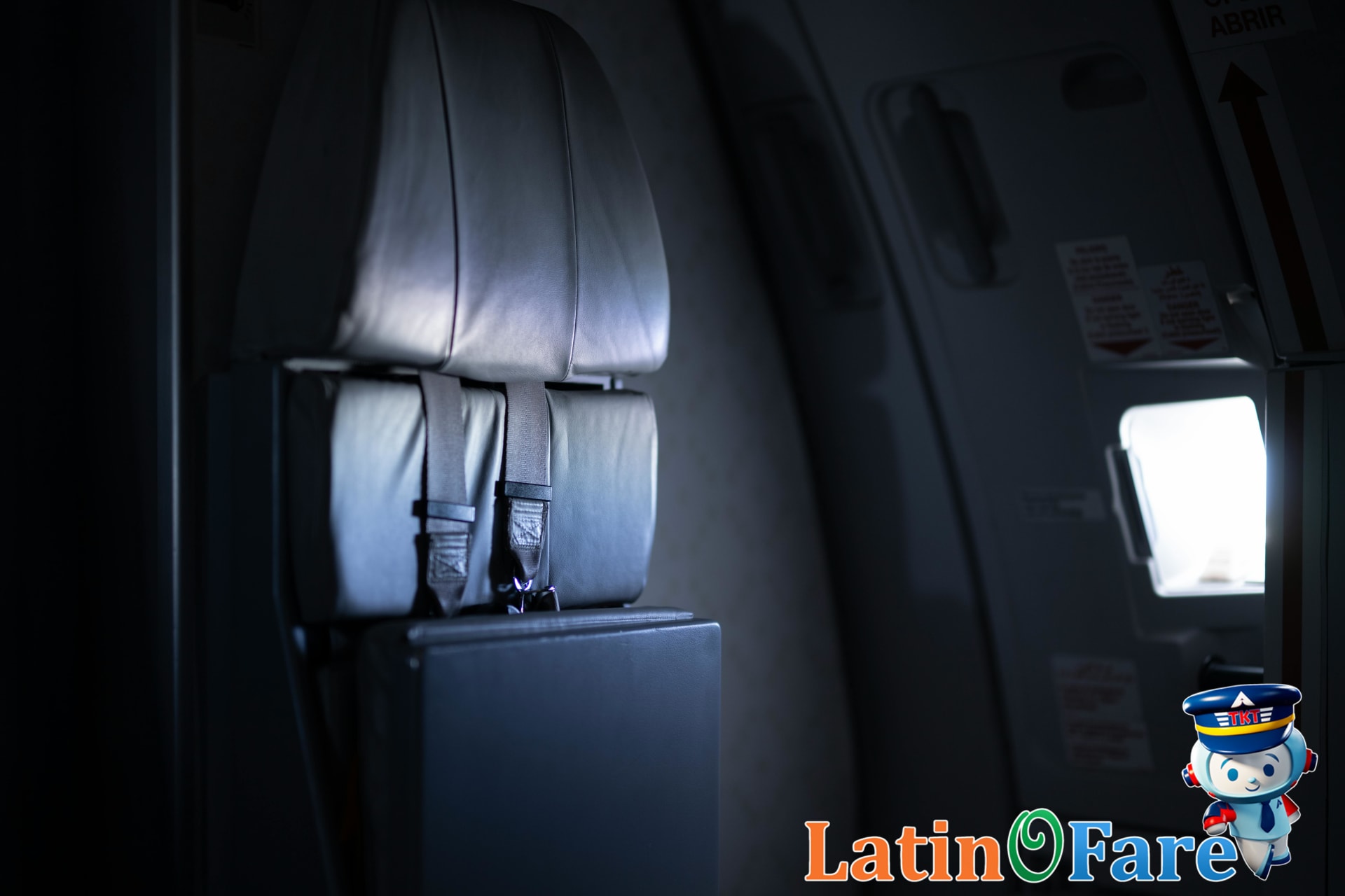 Packed airplane cabin at night with dimmed lights for overnight red-eye travel flights