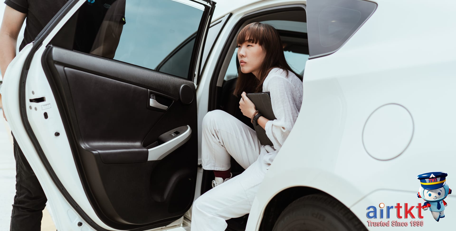 Happy travelers with rental car insurance confidence exiting rental vehicle
