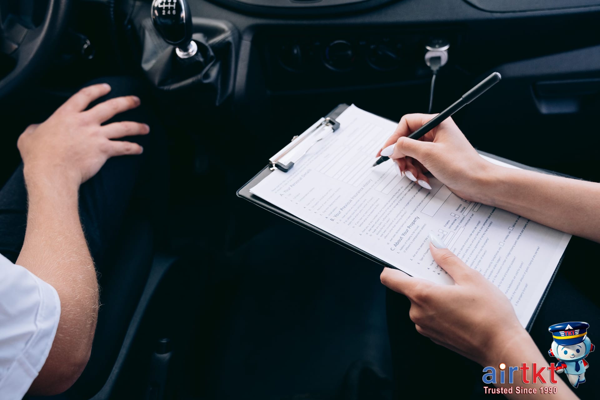 Driver signing rental car insurance documents at rental counter to decide needed coverage