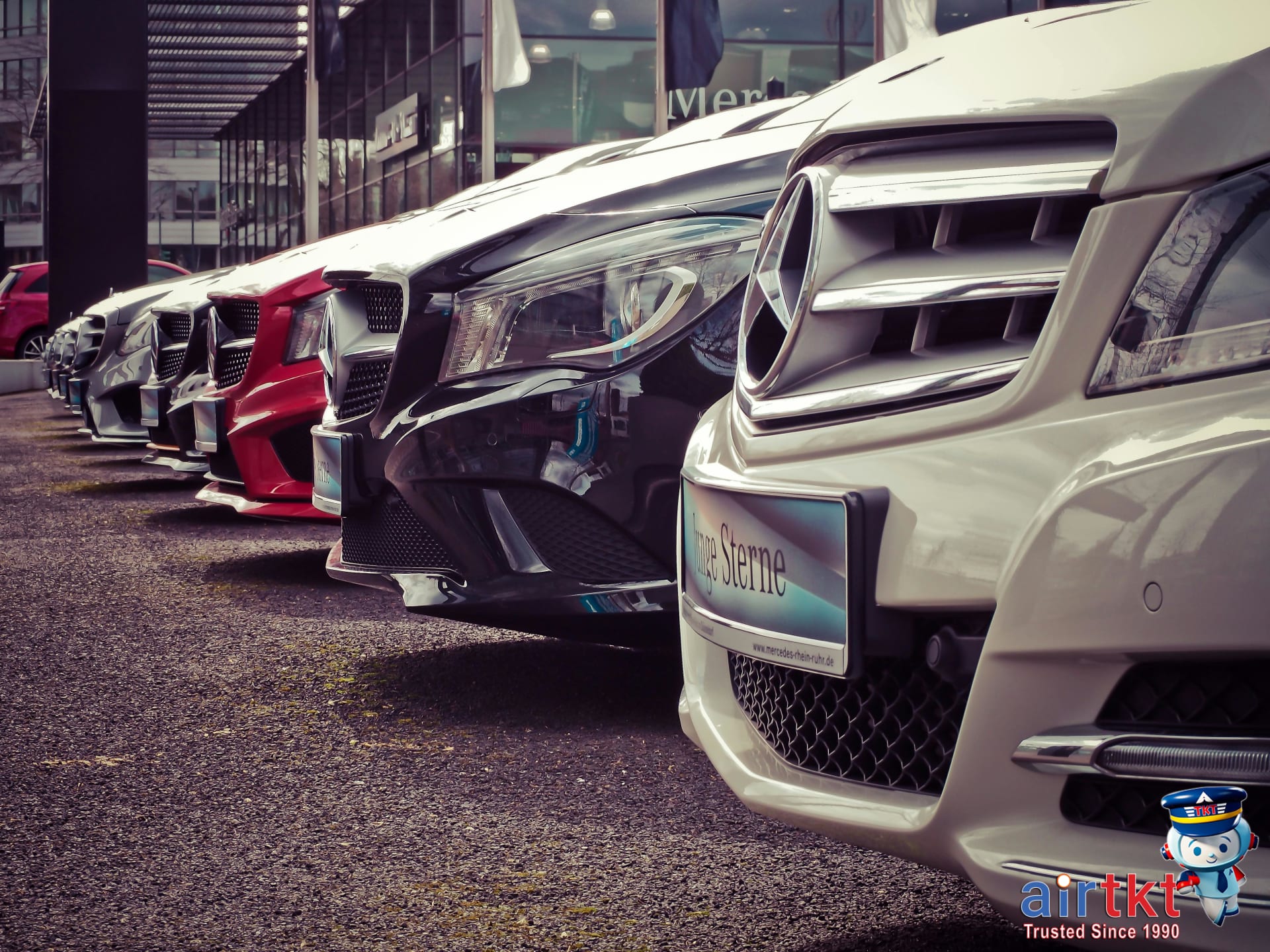 Rental cars lined up at dealership showing different rental car insurance options