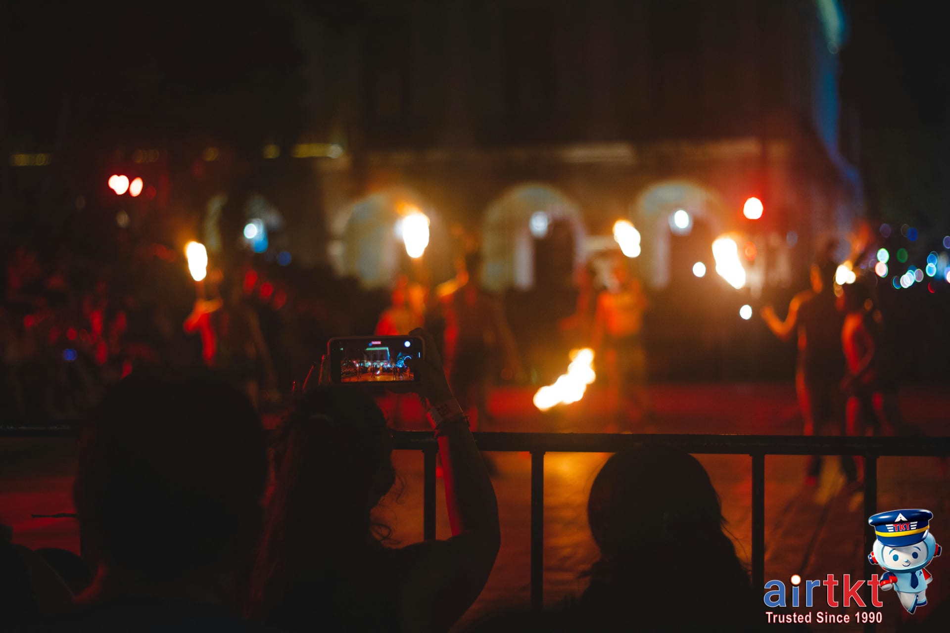 Nightlife scene with live music and tiki torches in Honolulu beach area