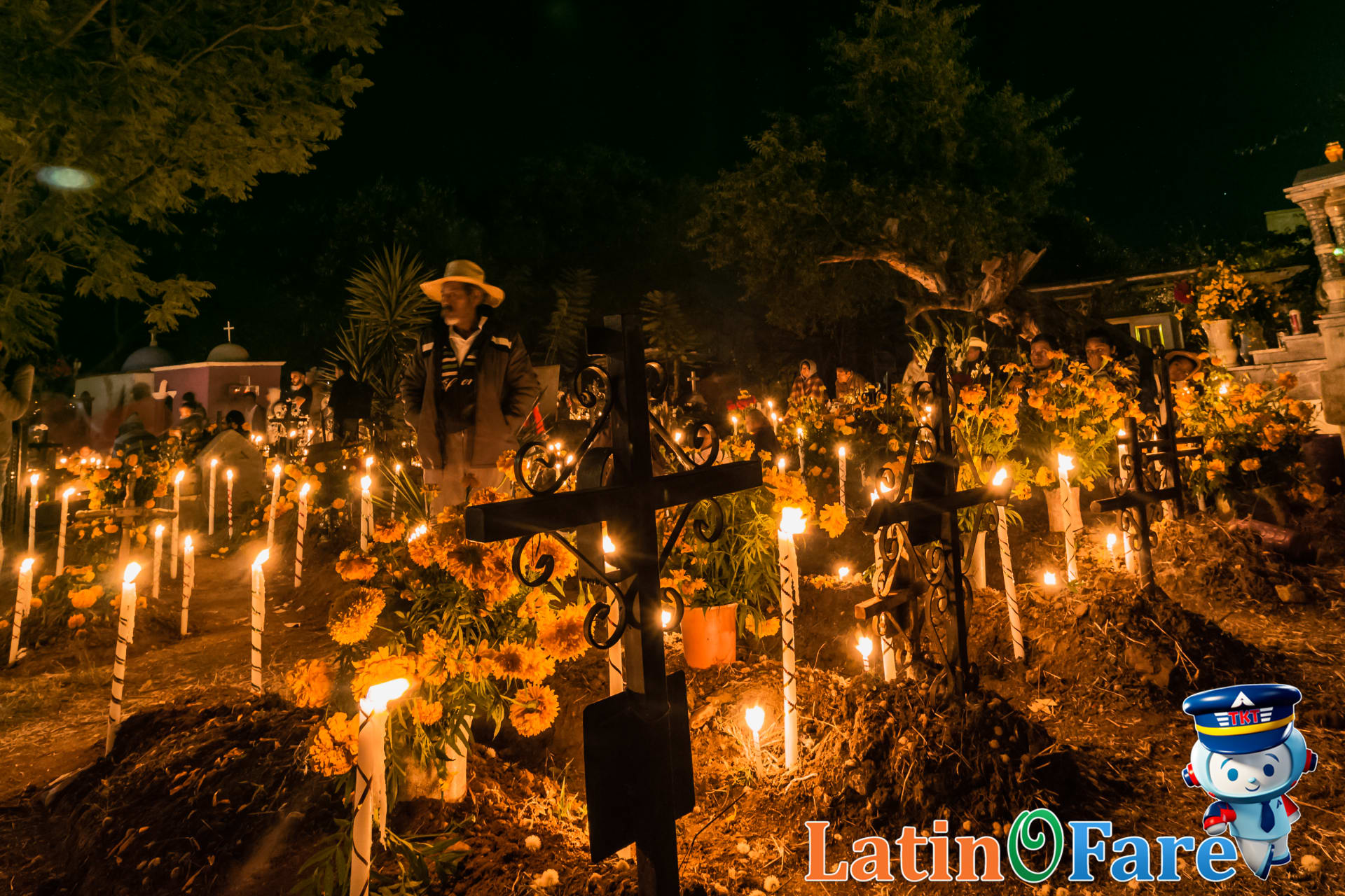 Pátzcuaro cemetery at night with candles and families for Day of the Dead traditions in Mexico