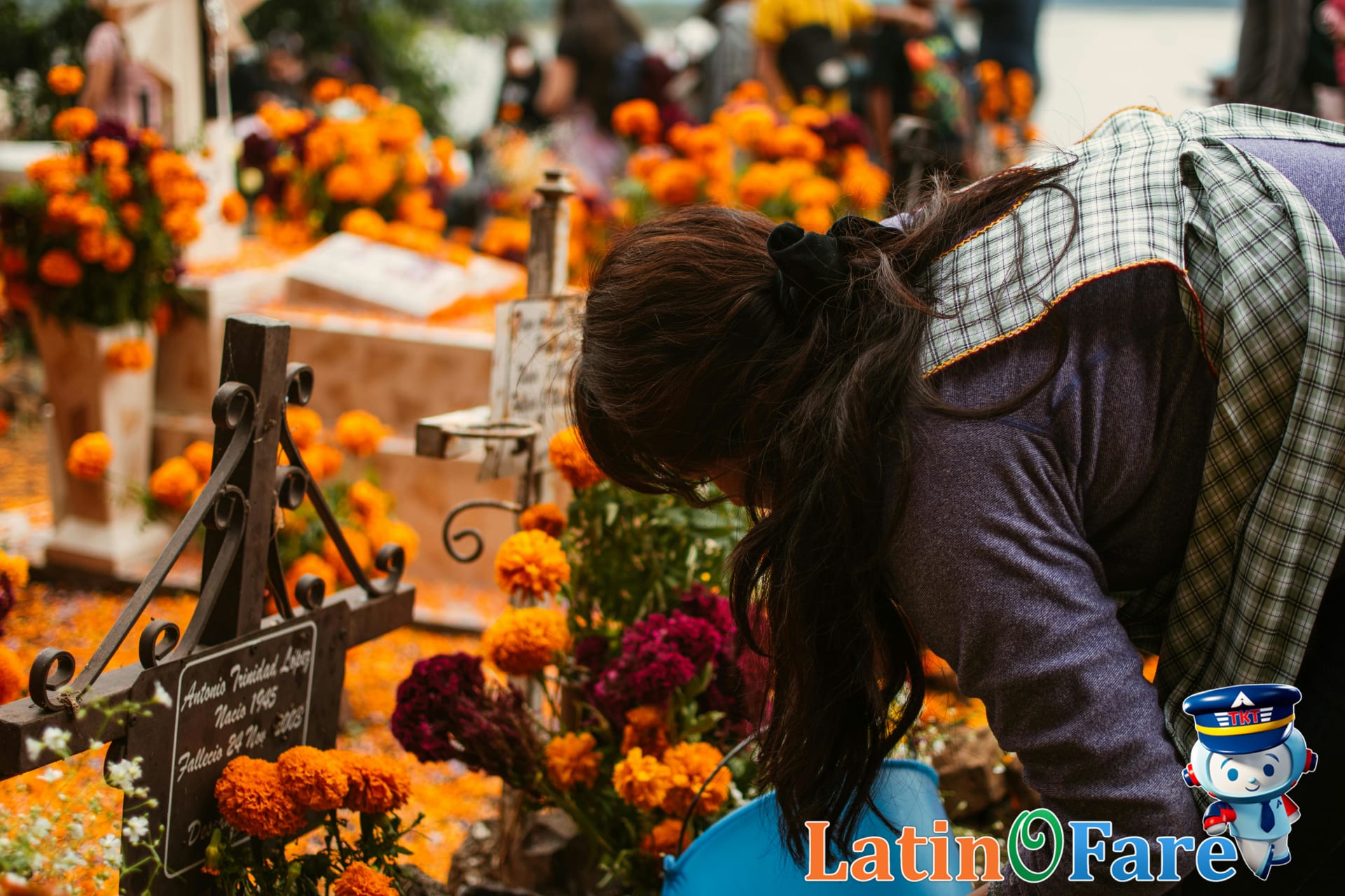 Family honors ancestors at cemetery for Day of the Dead in Mexico during festival evening