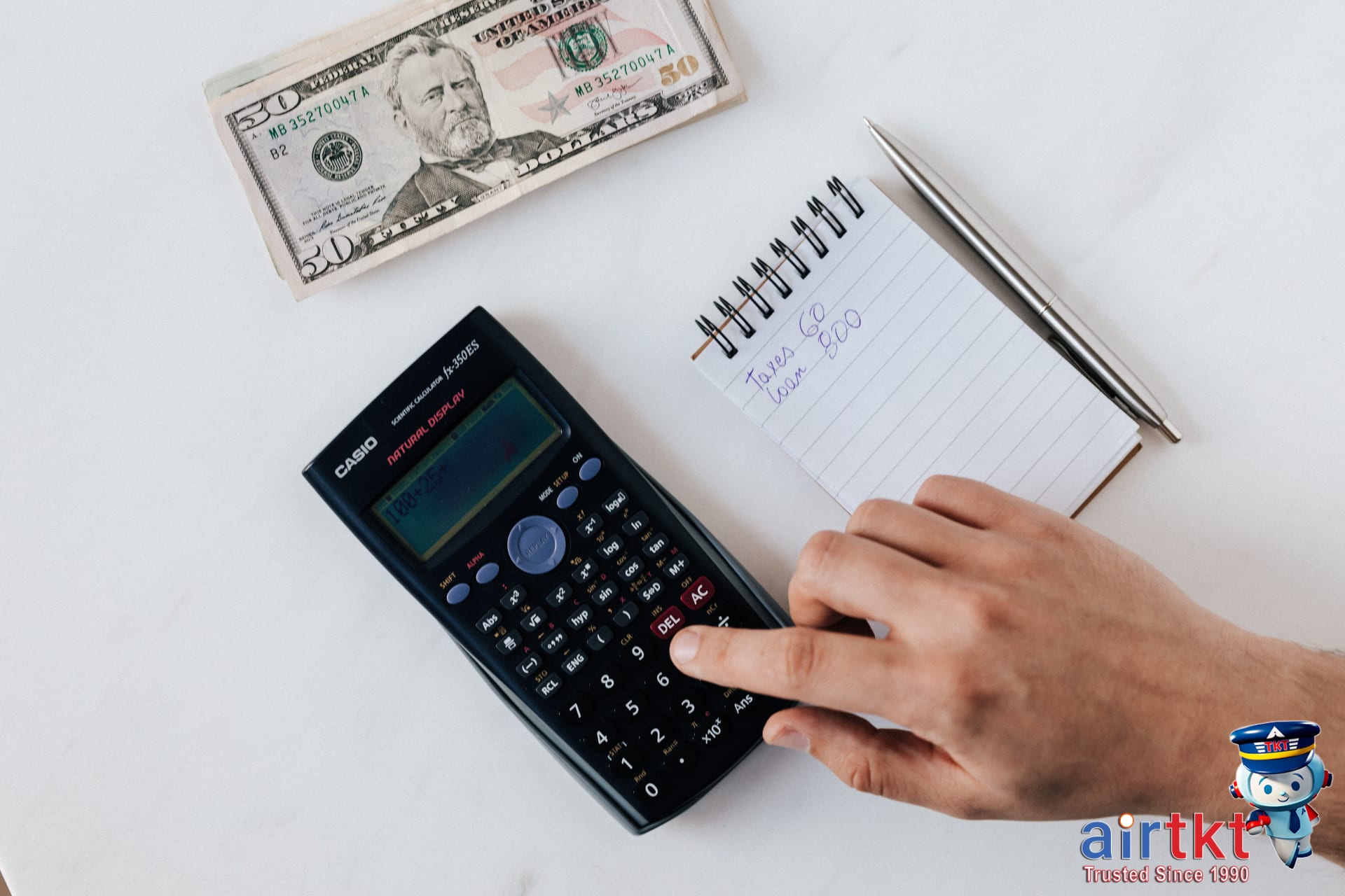 Traveler using a smartphone to plan budget and track travel costs including foreign transaction fees
