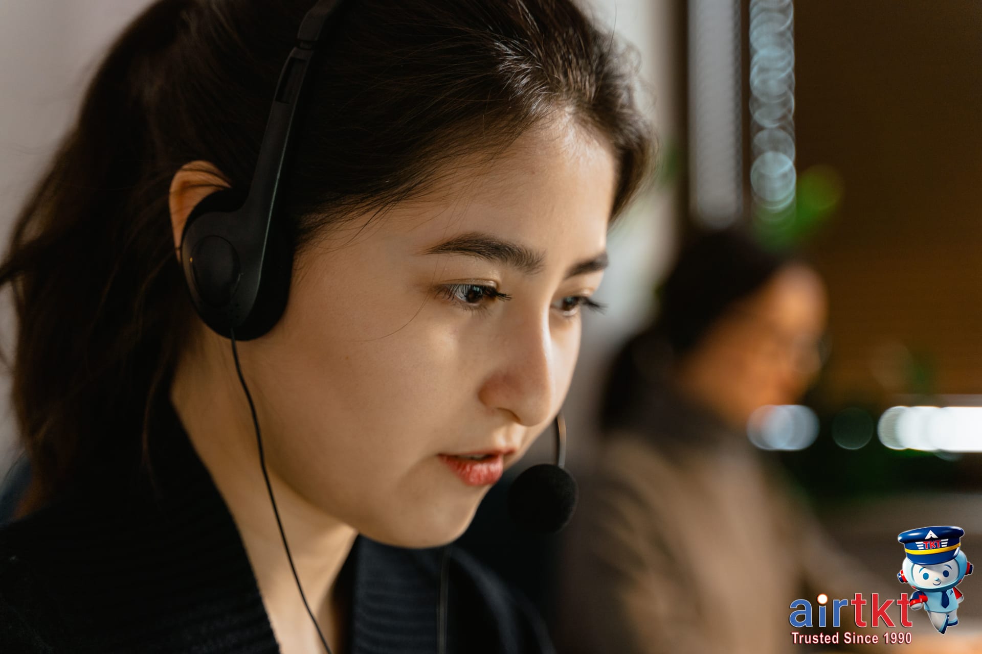 United Airlines MileagePlus customer support desk with representative assisting traveler