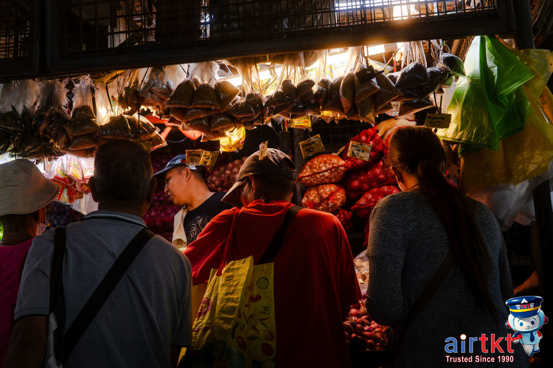 Bustling Manila local market with fresh produce and shoppers.