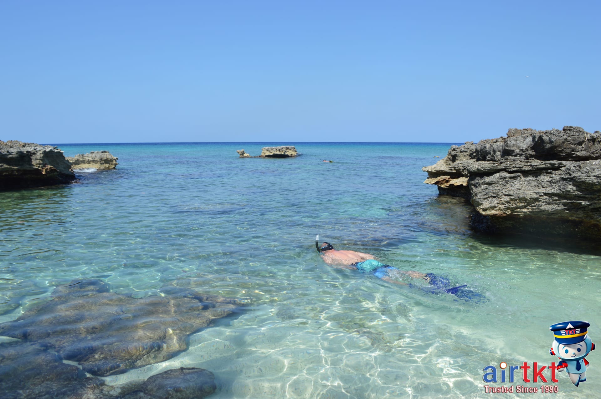 Snorkeler exploring vibrant coral reefs in Bahamas crystal-clear waters.