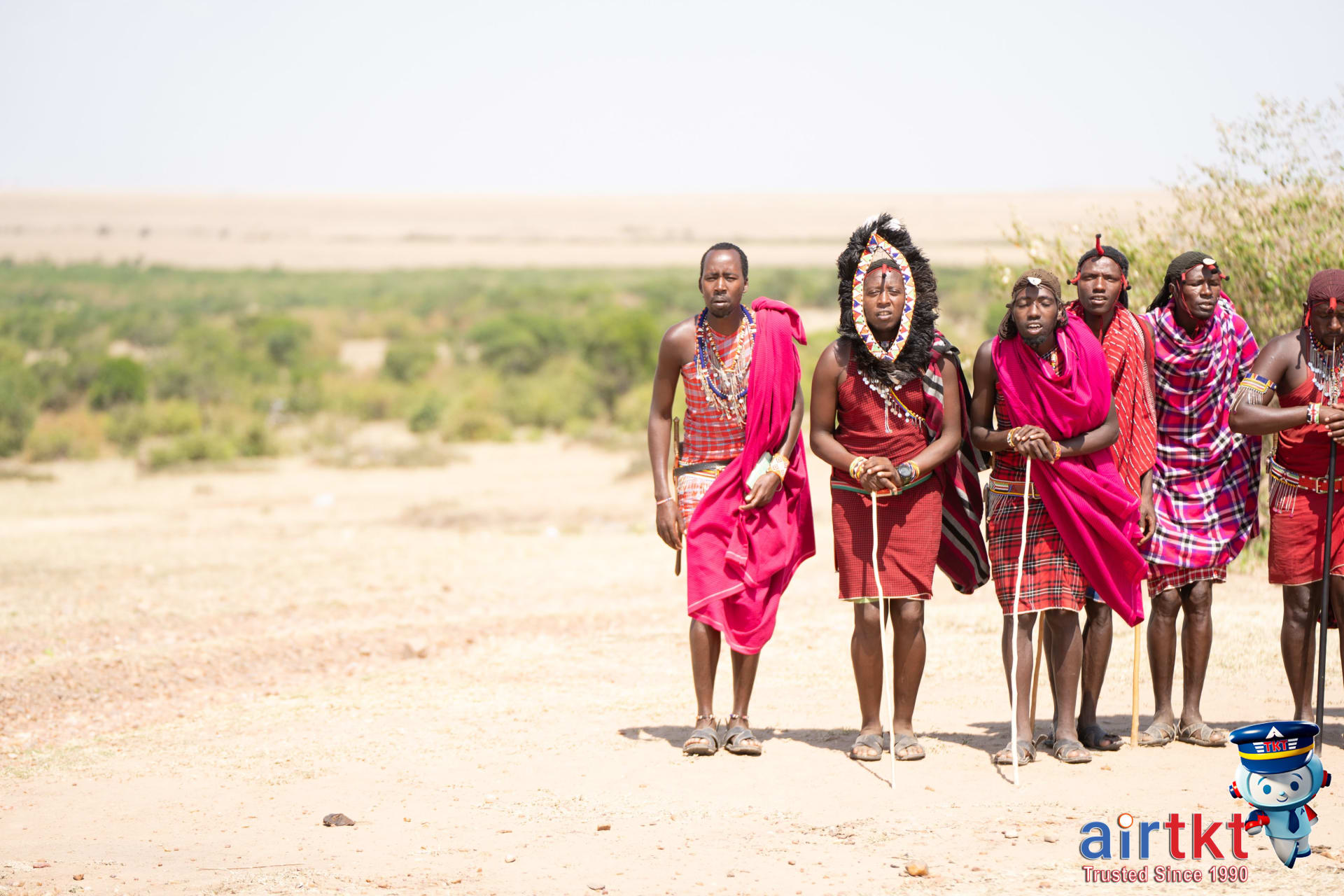 Maasai tribespeople in vibrant traditional attire near safari park Kenya.