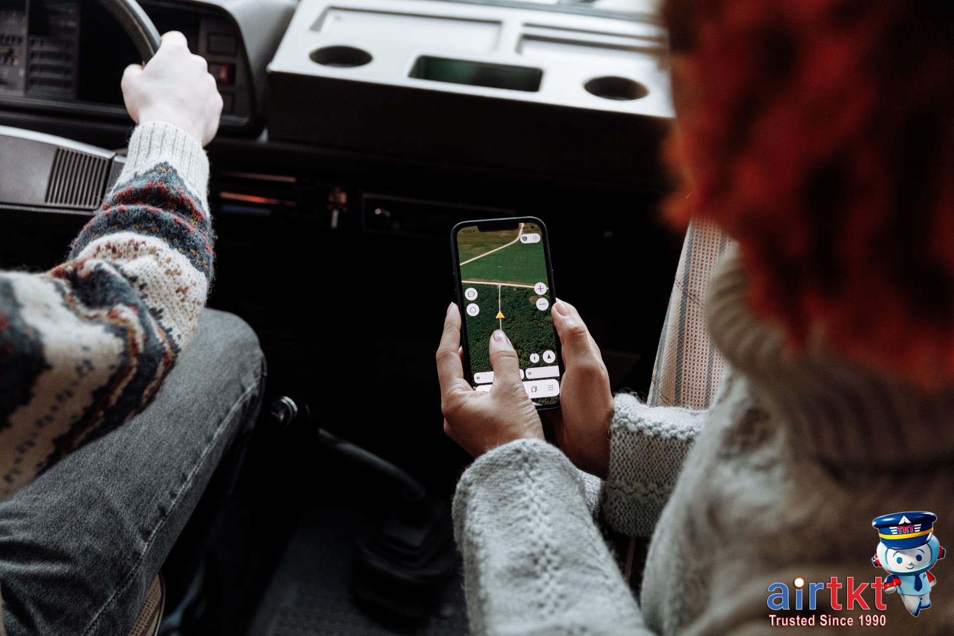 Planning Fourth of July travel with travel app on a smartphone outdoors