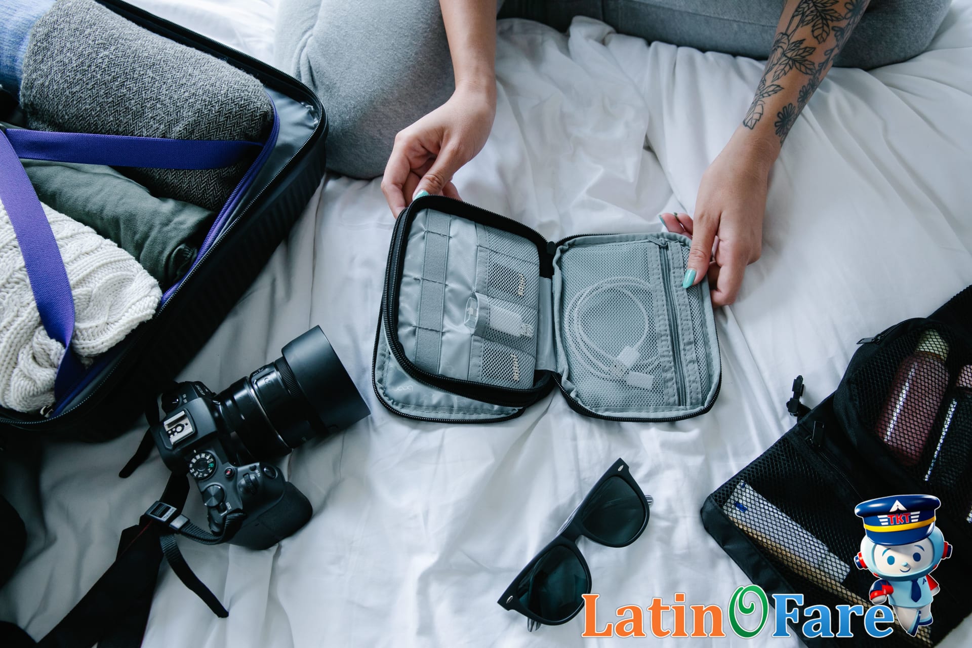 Essential backpacking gear arranged before packing for hiking trip on a bed